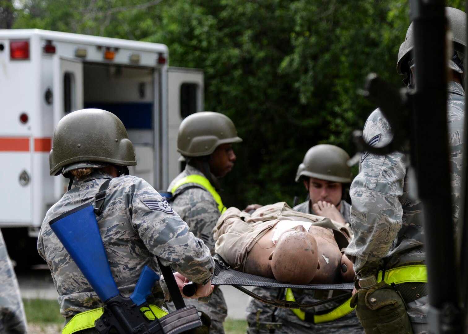 Airmen from the 59th Medical Wing transport mannequins, which simulates an injured patient, during the two-day deployment readiness training exercise July 25 at Joint Base San Antonio-Lackland, Texas. The training is required every two years, or prior to a deployment. (U.S. Air Force photo/Staff Sgt. Kevin Iinuma)