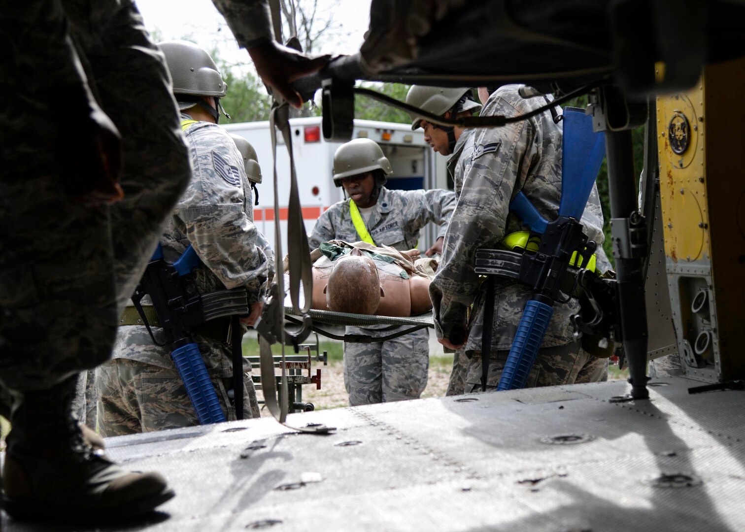 Airmen from the 59th Medical Wing transport mannequins, which simulate injured patients, during a two-day deployment readiness training exercise July 25 at Joint Base San Antonio-Lackland, Texas. The training is required every two years, or prior to a deployment. (U.S. Air Force photo/Staff Sgt. Kevin Iinuma)