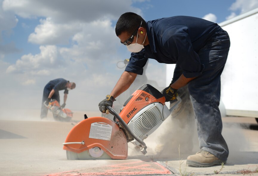 U.S. Air Force Senior Airman Nolan Nunez, 7th Civil Engineer Squadron pavements and heavy repair journeyman, utilizes a concrete saw on the flight line Sept. 29, 2014, at Dyess Air Force Base, Texas. The repair work was done to remove defective pavement. (U.S. Air Force photo by Airman 1st Class Kedesha Pennant/Released)