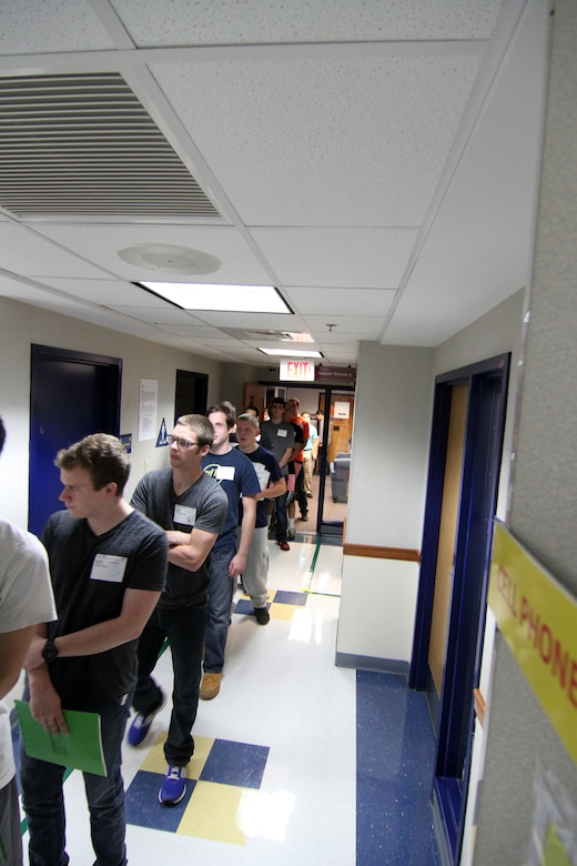 Applicants stand in line after recieving there initial paperwork packets after arriving to the Military Entrance Processing Station on Joint Base McGuire-Dix-Lakehurst, N.J., Oct. 7, 2014. (U.S. Army photo by Sgt. Richard W. Hoppe/Released)