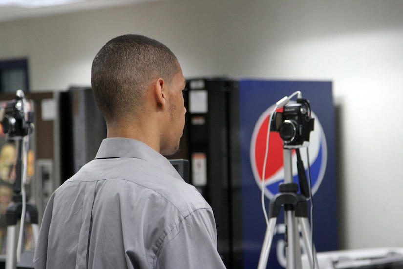 One applicant prepares to have his picture taken at the central command desk during processing at the Military Entrance Processing Station on Joint Base McGuire-Dix-Lakehurst, N.J., Oct. 7, 2014. (U.S. Army photo by Sgt. Richard W. Hoppe/Released)