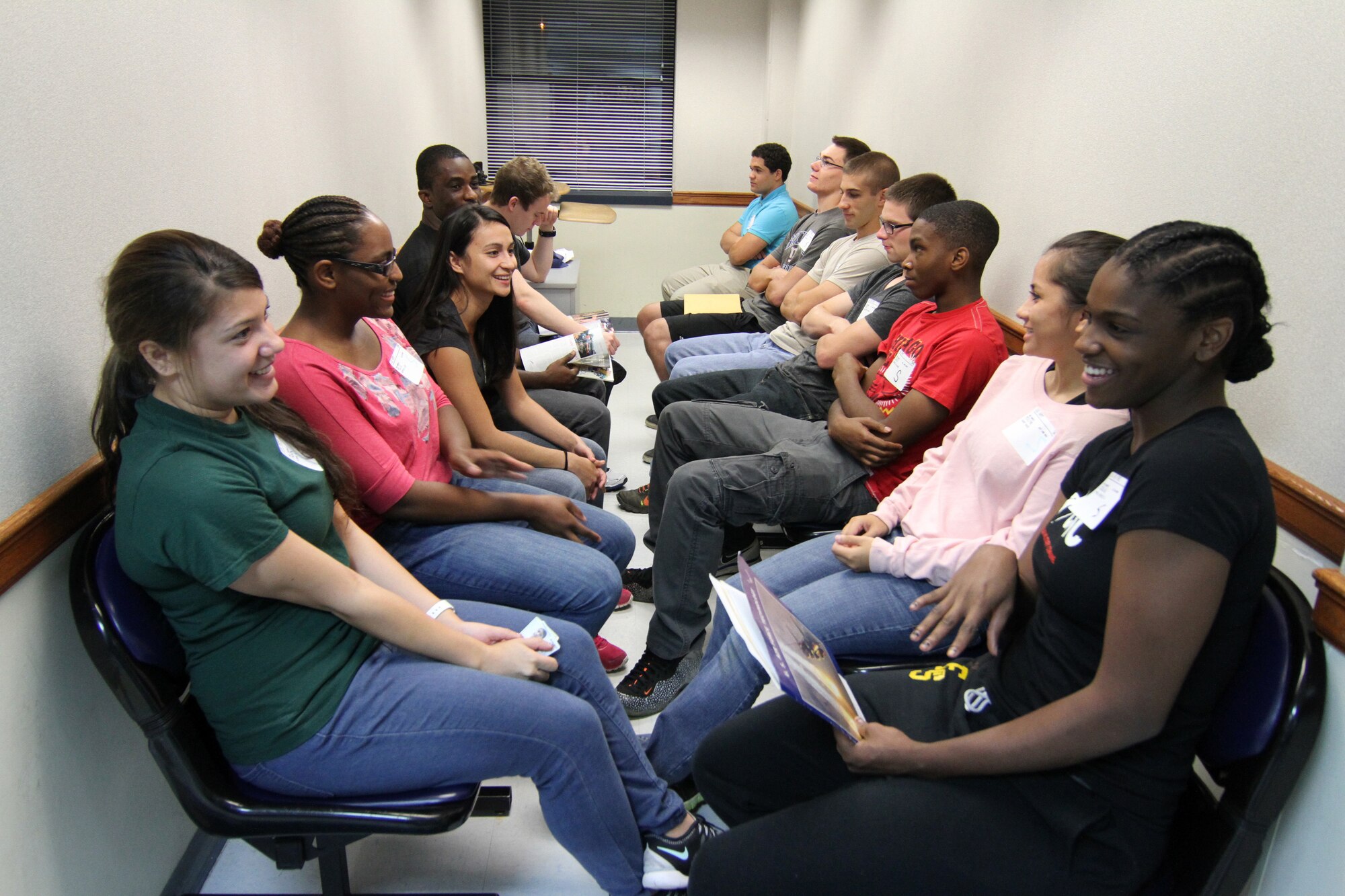Applicants engage in friendly conversation and joke with one another while waiting to be sent to their next evaluation at the Military Entrance Processing Station on Joint Base McGuire-Dix-Lakehurst, N.J., Oct. 7, 2014. (U.S. Army photo by Sgt. Richard W. Hoppe/Released)