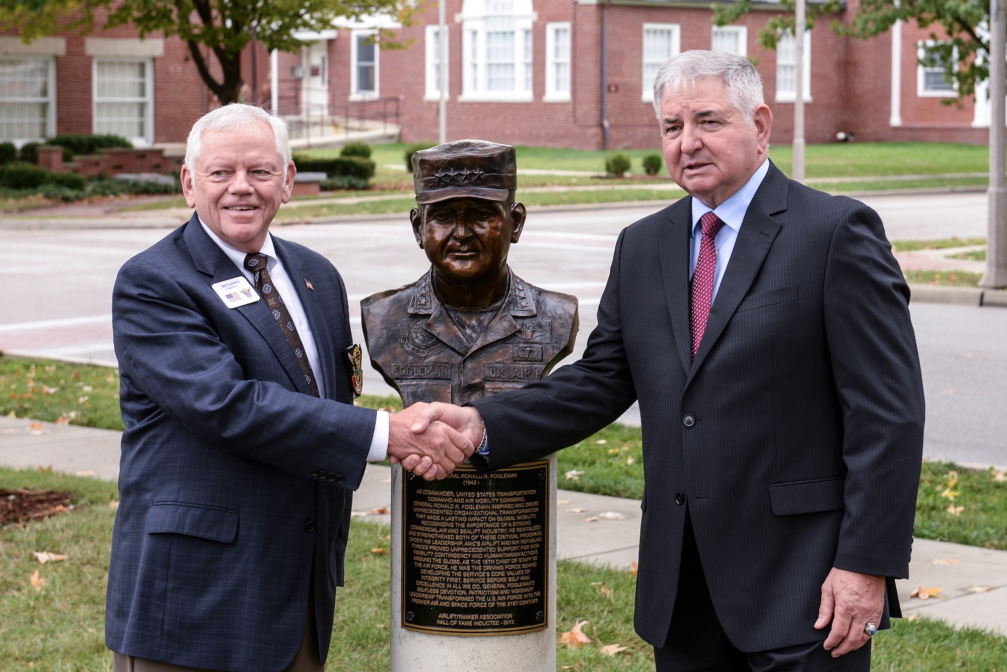 Retired Gen. Art Lichte, former Air Mobility Command commander and Airlift/Tanker Association Chairman, and retired Gen. Ronald R. Fogleman stand next to the newly unveiled bust of Fogleman following a ceremony recognizing him as the 23rd inductee into the Airlift/Tanker Association's Hall of Fame Oct. 9, 2014, at Scott Air Force Base, Illinois. Fogleman served for 34 years, including serving as the Air Force Chief of Staff, before retiring in 1997. He was recognized during his career by receiving the Silver Star, two Distinguished Flying Crosses and received a Purple Heart for injuries he received while ejecting from his crippled aircraft. (U.S. Air Force photo/Staff Sgt. Jonathan Fowler)