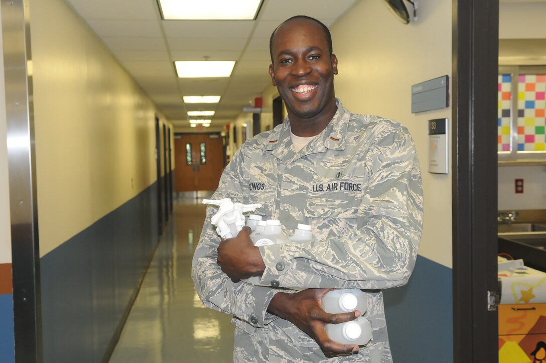 2nd Lieutenant Alex Hastings, 579th Medical Group Infection Control Officer, ensuring sanitizer bottles are not expired and refilled throughout the 579th Medical Group buildings on Joint Base Anacostia-Bolling. (U.S. Air Force Photo by Staff Sgt. Jarimaris Garcia)

