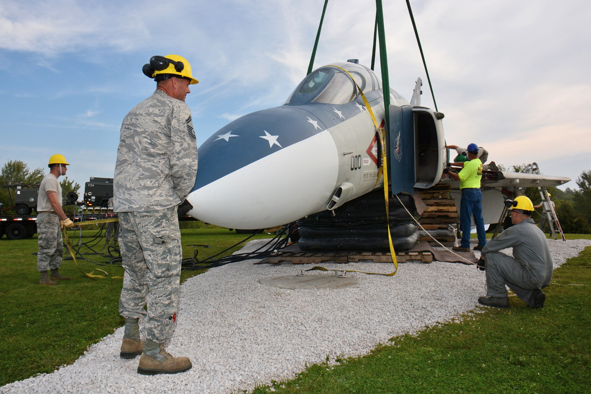 Members of the Wisconsin Air National Guard's 115th Fighter Wing Crash Damage or Disabled Aircraft Recovery team, reconstruct an F-4S Phantom static display on the grounds of Truax-Longmire Veterans of Foreign Wars Post 8483 in Madison, Wis., Sept. 20, 2014. The eight airmen representing the 115 FW CDDAR team were able to complete critical training requirements by removing and relocating the aircraft to Madison from its previous home at Camp Atterbury, Ind. (Air National Guard Photo by Master Sgt. Paul Gorman)