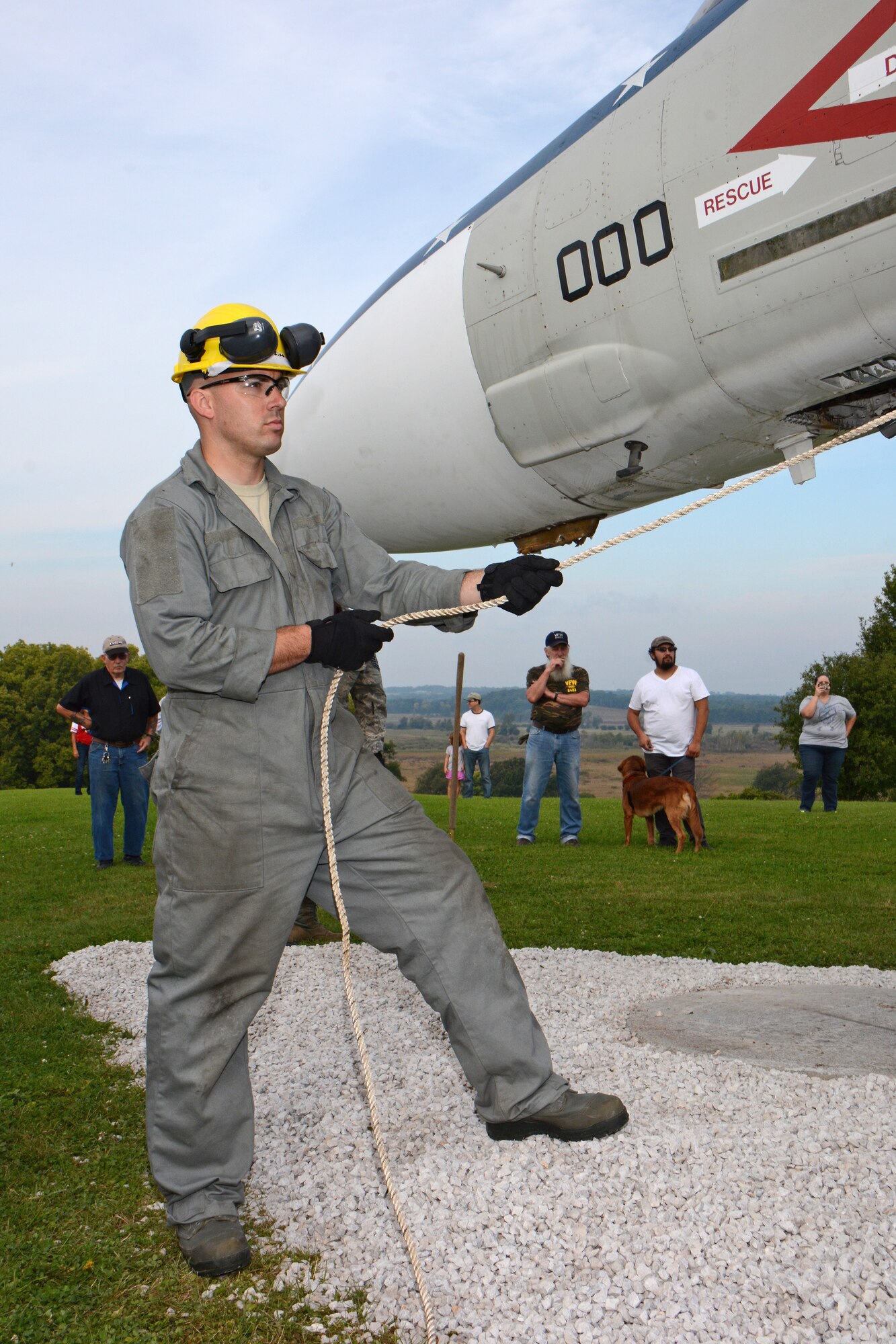 Veterans of Foreign Wars members look on as Technical Sgt. Micah Agee, a member of the 115th Fighter Wing Crash Damage or Disabled Aircraft Recovery team, guides the fusalage of an F-4S Phantom aircraft as it's relocated for display on the grounds of Truax-Longmire VFW Post 8483 in Madison, Wis., Sept. 20, 2014. The eight airmen representing the 115 FW CDDAR team were able to complete critical training requirements by removing and relocating the aircraft to Madison from its previous home at Camp Atterbury, Ind. (Air National Guard Photo by Master Sgt. Paul Gorman)