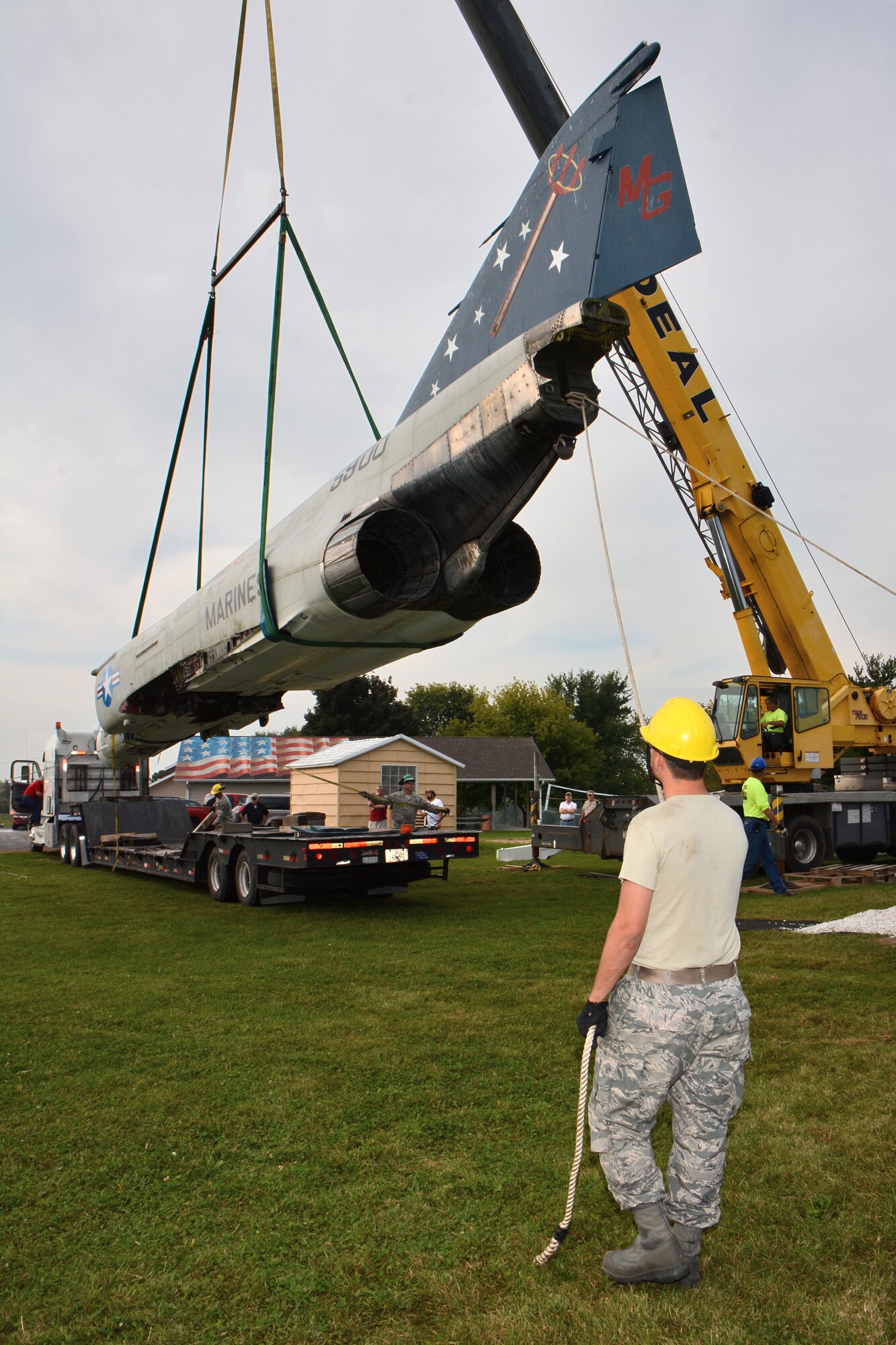 Staff Sgt. Tracy Hermanson, 115th Fighter Wing Crash Damage or Disabled Aircraft Recovery team member, guides the fusalage of an F-4S Phantom aircraft as it's relocated for display on the grounds of Truax-Longmire Veterans of Foreign Wars Post 8483 in Madison, Wis., Sept. 20, 2014. The eight airmen representing the 115 FW CDDAR team were able to complete critical training requirements by removing and relocating the aircraft to Madison from its previous home at Camp Atterbury, Ind. (Air National Guard Photo by Master Sgt. Paul Gorman)