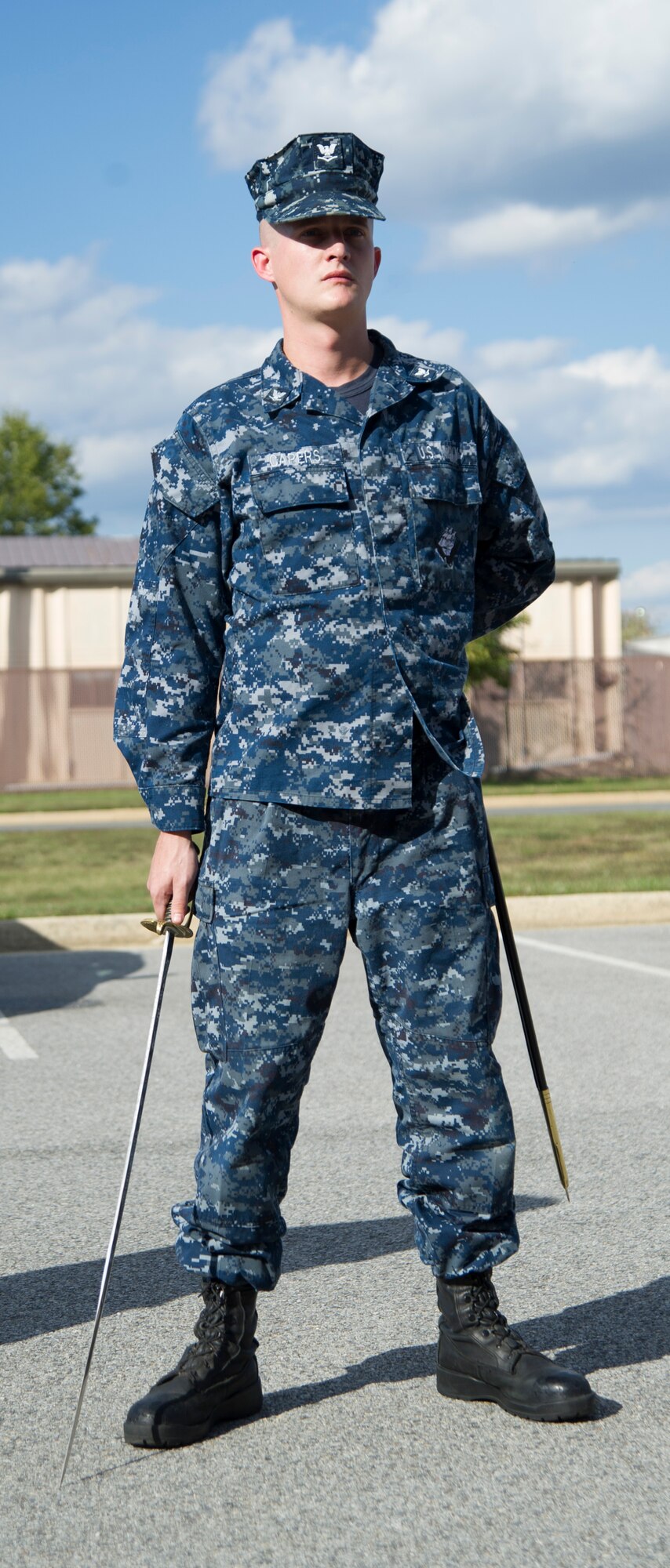 Petty Officer 3rd Class Jeremy Capers, a Fleet Logistics Support Squadron 1 aircraft structural mechanic, waits for his next command during sword and guidon training at Joint Base Andrews, Md., Oct. 8, 2014. The training is part of the first joint Corporals Course here. It is designed to provide students with the knowledge and skills necessary to be successful small-unit leaders. (U.S. Air Force photo/Airman 1st Class Ryan J. Sonnier)