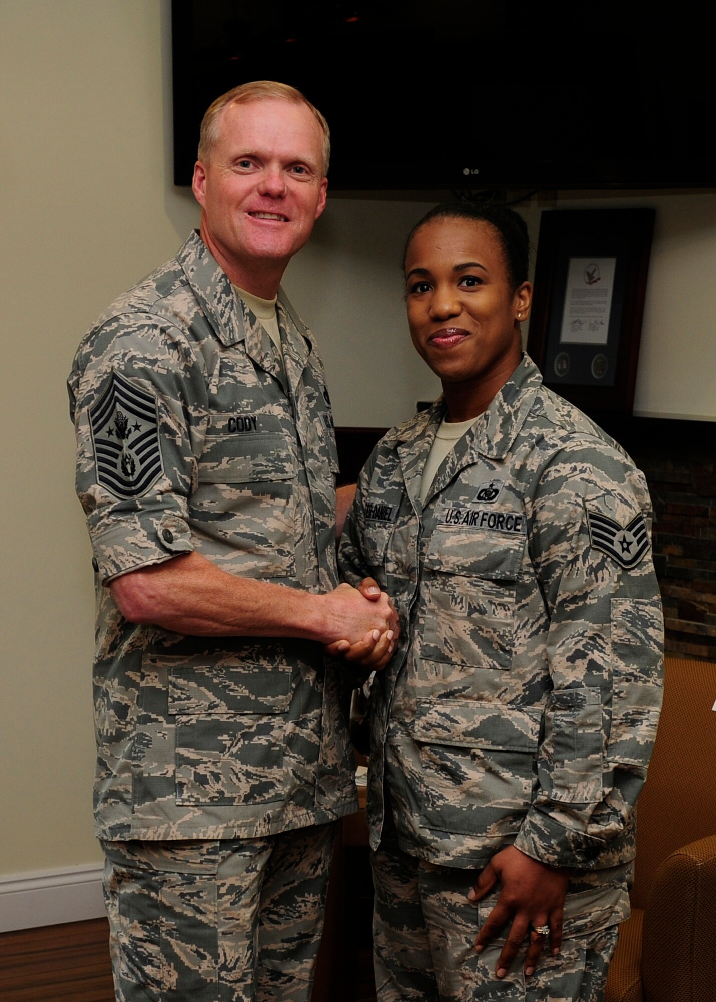 During a visit to Air Forces Northern Oct. 7, Chief Master Sergeant of the Air Force James Cody presented Staff Sgt. Theresa Carter-Daniel with his coin for exemplary duty performance. She is assigned to the Air Force Rescue Coordination Center. (Photo by Tech. Sgt. Javier Cruz Jr.)