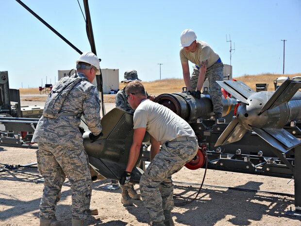 Air Force Combat Ammunition Center students assemble ammunition during the Iron Flag exercise Aug. 22, 2014, at Beale Air Force Base, Calif. AFCOMAC is a school that provides the Air Force munitions community with advanced training in mass combat ammunition planning and production techniques. (U.S. Air Force photo by Airman 1st Class Ramon A. Adelan/Released)