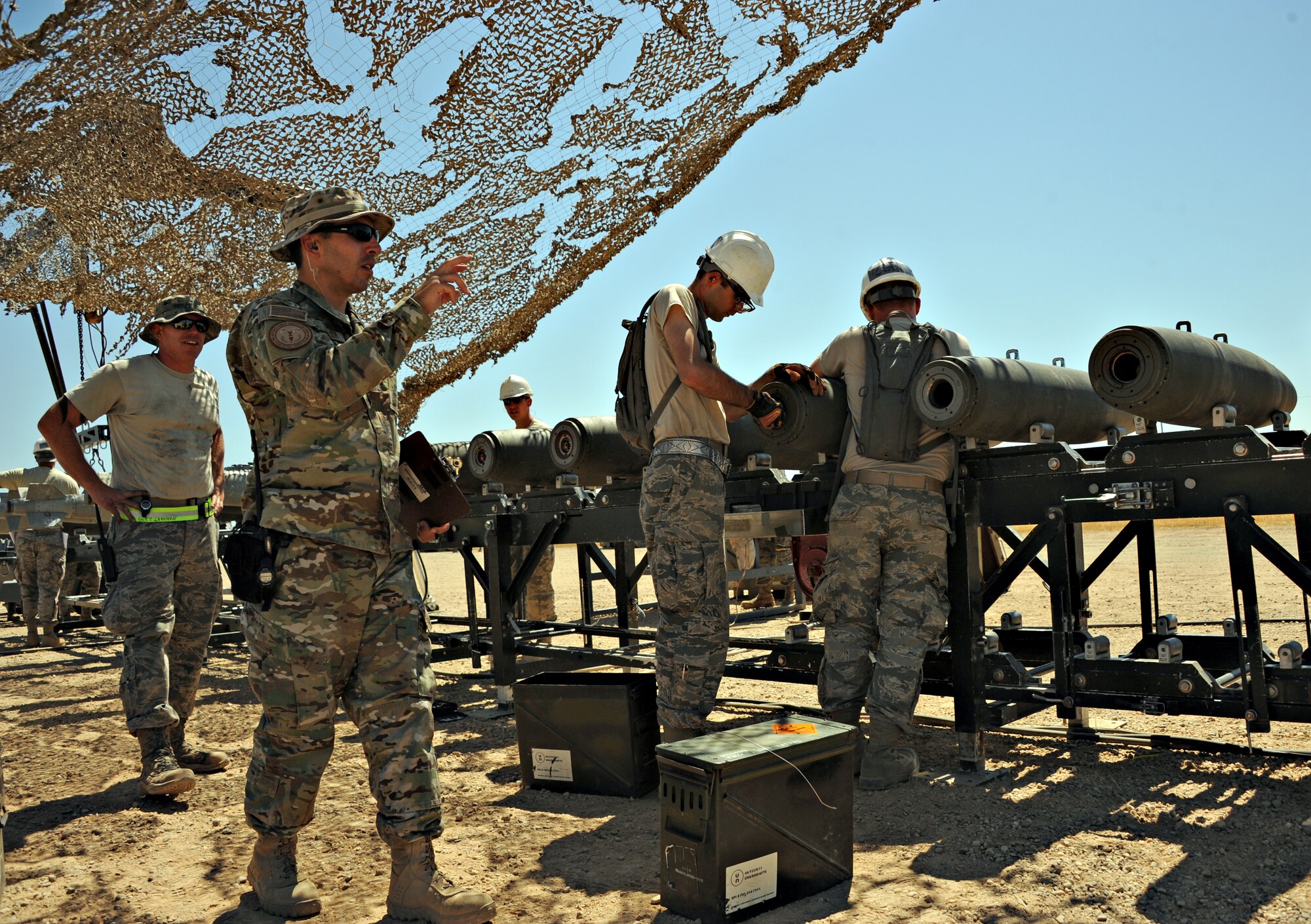 Tech. Sgt. Craig Taylor, Air Force Combat Ammunition Center instructor, evaluates the students on ammunition production during the Iron Flag exercise Aug. 22, 2014, at Beale Air Force Base, Calif. AFCOMAC is a school  for senior airmen and above as upgrade training to provide the Air Force munitions community with advanced training in mass combat ammunition planning and production techniques. (U.S. Air Force photo by Airman 1st Class Ramon A. Adelan/Released)