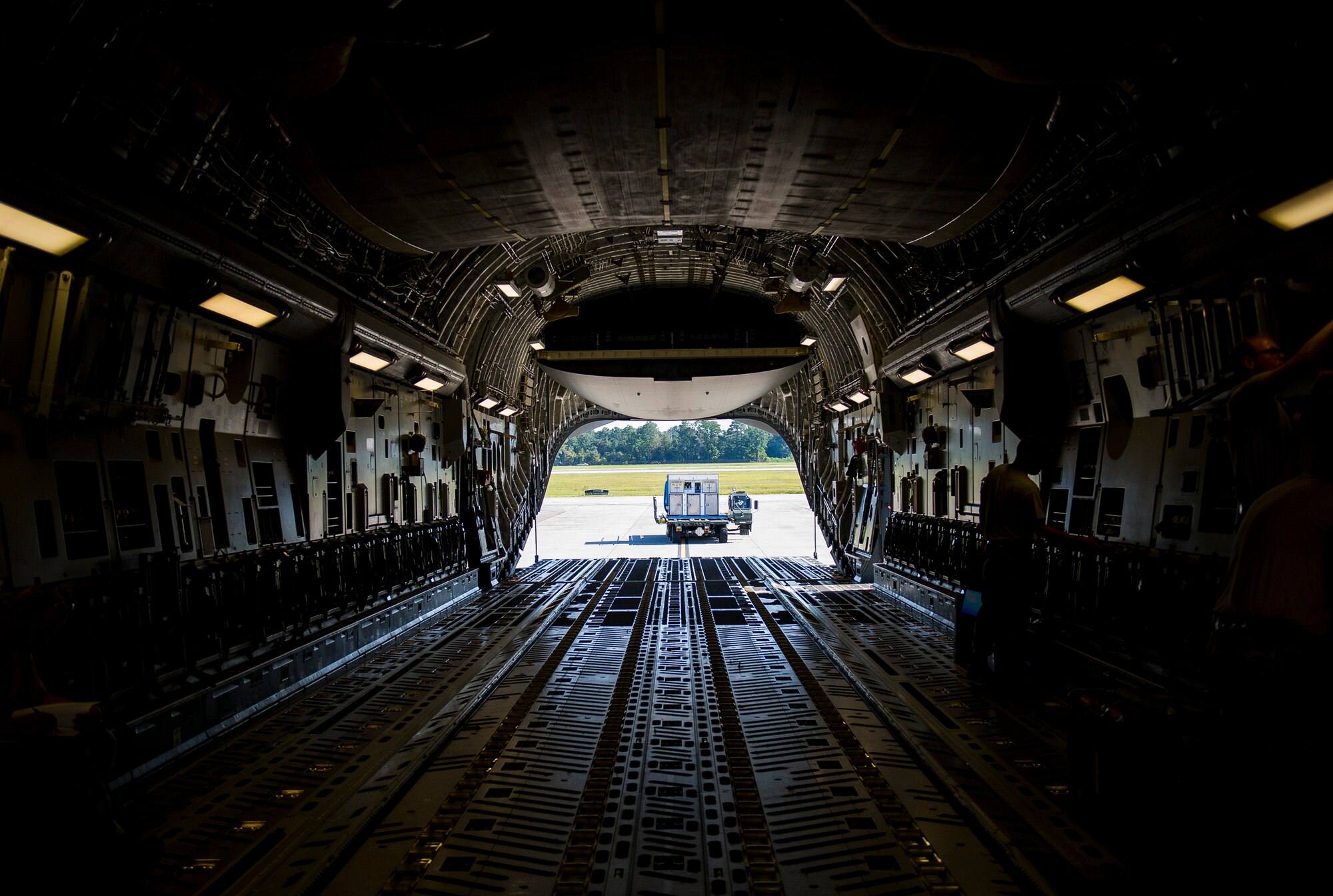 A 437th Aerial Port Squadron Atlas K-Loader sits behind a C-17 Globemaster III, Oct. 8, 2014, on the flightline at Joint Base Charleston, S.C. In addition to their normal duties of loading and unloading our C-17s, the 437th APS provides support for the nation’s premier rapid deployment forces: XVIII Airborne Corps, 82nd Airborne Division, Joint Special Operations Command and the 43rd Airlift Wing. The squadron is prepared to meet short-notice, worldwide mobility taskings in support of national objectives, and plans and executes support for more than 50 percent of all joint airborne and air transportability training missions flown by Air Mobility Command and Reserve forces in support of Joint Operations. (U.S. Air Force photo/Airman 1st Class Clayton Cupit)