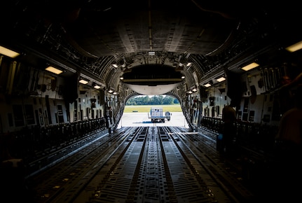 A 437th Aerial Port Squadron Atlas K-Loader sits behind a C-17 Globemaster III, Oct. 8, 2014, on the flightline at Joint Base Charleston, S.C. In addition to their normal duties of loading and unloading our C-17s, the 437th APS provides support for the nation’s premier rapid deployment forces: XVIII Airborne Corps, 82nd Airborne Division, Joint Special Operations Command and the 43rd Airlift Wing. The squadron is prepared to meet short-notice, worldwide mobility taskings in support of national objectives, and plans and executes support for more than 50 percent of all joint airborne and air transportability training missions flown by Air Mobility Command and Reserve forces in support of Joint Operations. (U.S. Air Force photo/Airman 1st Class Clayton Cupit)