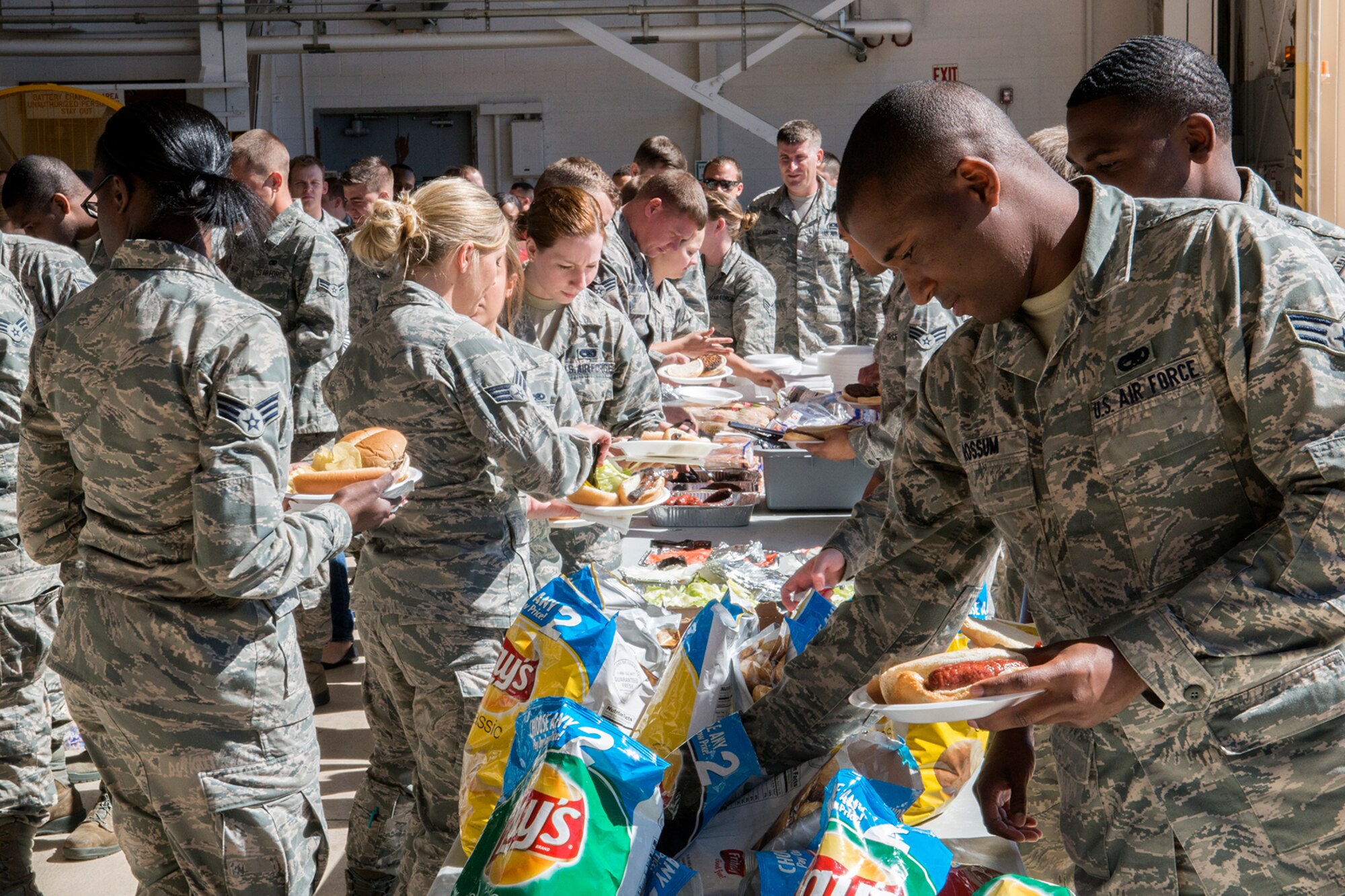 Airmen are treated to hamburgers and hotdogs prior to the start of the Gatorfest Awards Ceremony, Oct. 4, 2014, Barksdale Air Force Base, La. Gatorfest is an annual event held to thank Airmen of the various maintenance squadrons for their outstanding work in supporting the 307th Bomb Wing's B-52 operational mission. (U.S. Air Force photo by Master Sgt. Greg Steele/Released)