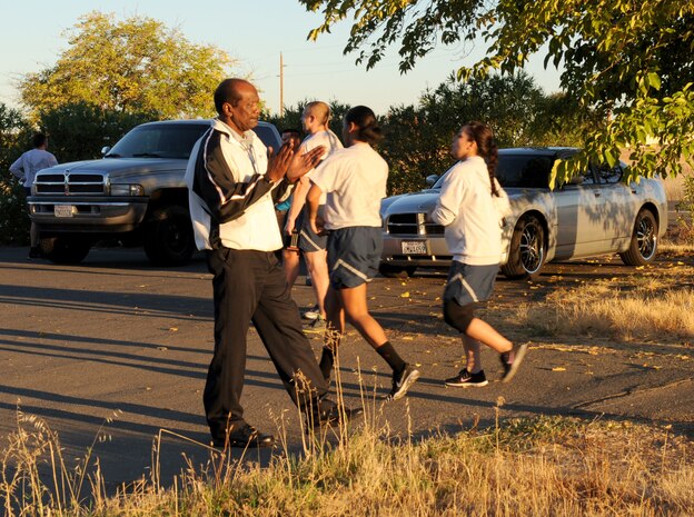 Daniel Lamons, Domestic Abuse Victim Advocate, congratulates 5K run participants on Beale Air Force Base, Calif., Oct. 8, 2014. The run was in observance of Domestic Violence Awareness Month. (U.S. Air Force photo by Staff Sgt. Robert M. Trujillo/Released)