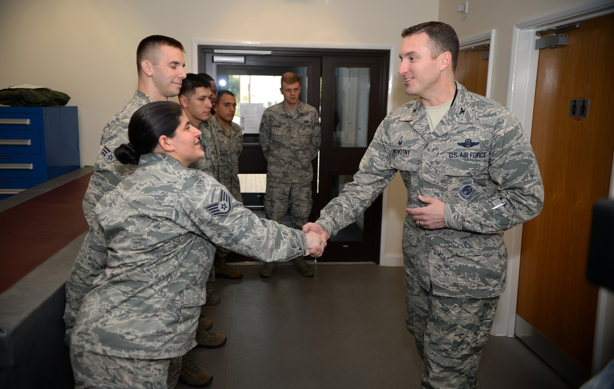 Col. Robert Novotny, 48th Fighter Wing commander, says “thank you” to members of the 48th Operations Support Squadron Air Crew Flight Equipment shop on Royal Air Force Lakenheath, England, Oct. 9, 2014. Members of the 48th OSS AFE shop ensured the parachute in the seat deployed properly after a pilot ejected from an F-15D Eagle on Oct. 8, 2014. (U.S. Air force photo by Staff Sgt. Emerson Nuñez/Released)