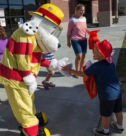 Sparky the fire dog greets children during a Joint Base Charleston Fire Department fire prevention week event Oct. 7, 2014, at the Air Base Exchange on JB Charleston, S.C. Fire prevention Week was Oct. 5 through 11, and the JB Charleston Fire Department hosted several events around the Air Base and Weapons Station. Fire prevention week was established in 1925 by President Calvin Coolidge when he became aware that close to 15,000 American citizens had been killed in fires the previous year. (U.S. Air Force photo/Airman 1st Class Clayton Cupit)
