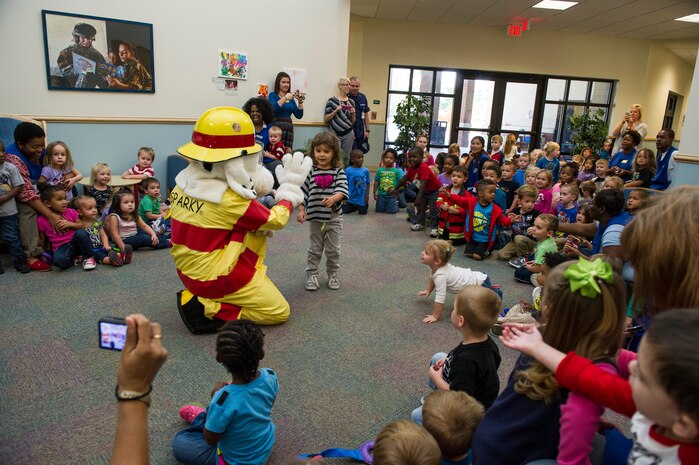 Sparky the fire dog visits children at the Brig. Gen. Thomas R. Mikolajcik Child Development Center, Oct. 6, 2014, on Joint Base Charleston, S.C. Fire prevention Week was Oct. 5 through 11, and the JB Charleston Fire Department hosted several events around the Air Base and Weapons Station. Fire prevention week was established in 1925 by President Calvin Coolidge when he became aware that close to 15,000 American citizens had been killed in fires the previous year. (U.S. Air Force photo/Airman 1st Class Clayton Cupit)