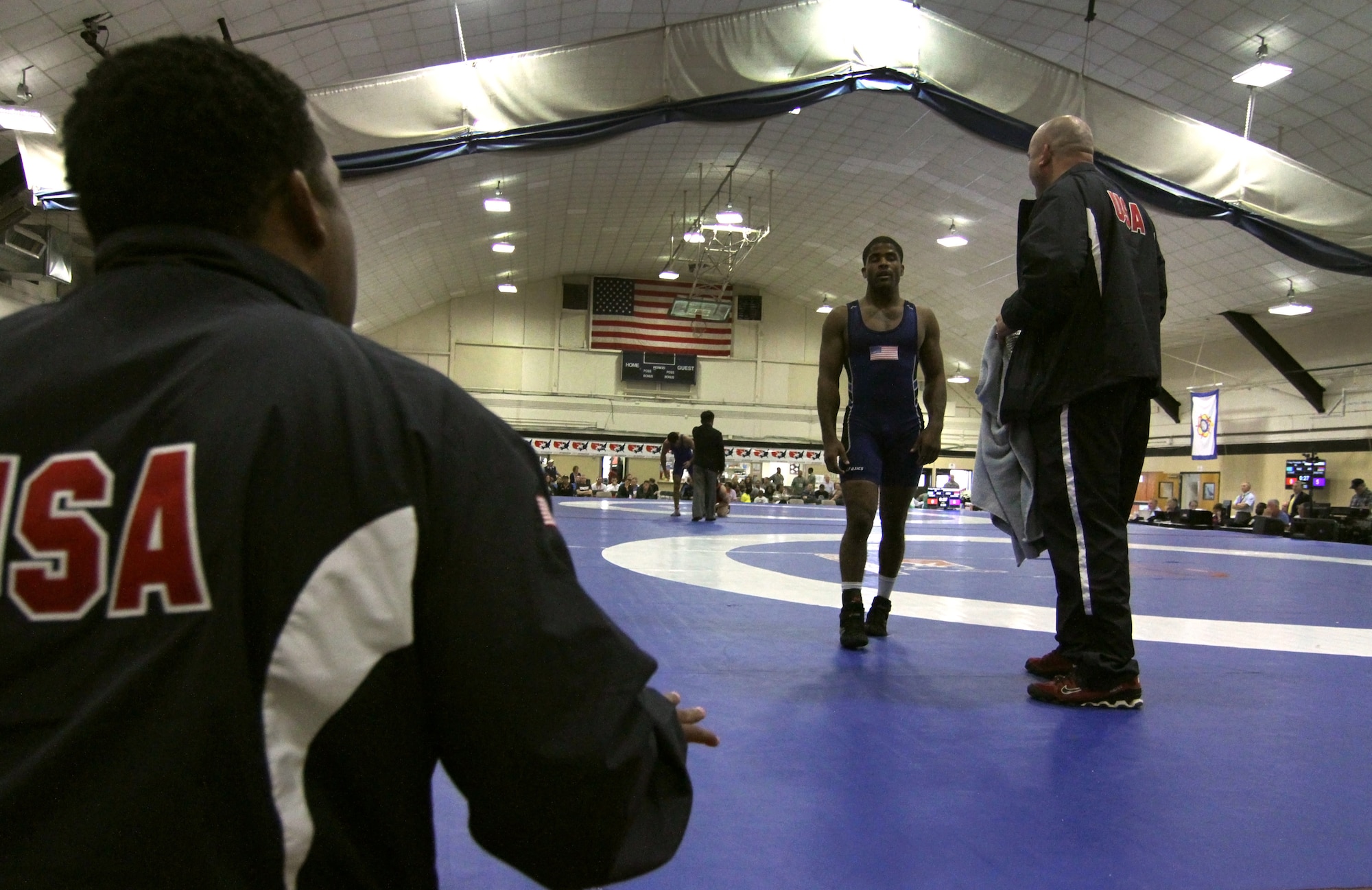 Army Sgt. Jamel Johnson, a unit supply specialist from Winston-Salem, North Carolina, returns to his corner for a quick rest and advice from his coaches during the Military Sports Council World Military Wrestling Championships at Joint Base McGuire-Dix-Lakehurst, N.J., Oct. 3, 2014. Johnson won his match Chamara Perera from Sri Lanka 16-5 and placed fifth overall.(U.S. Army photo by Sgt. Adrian Borunda/Released)