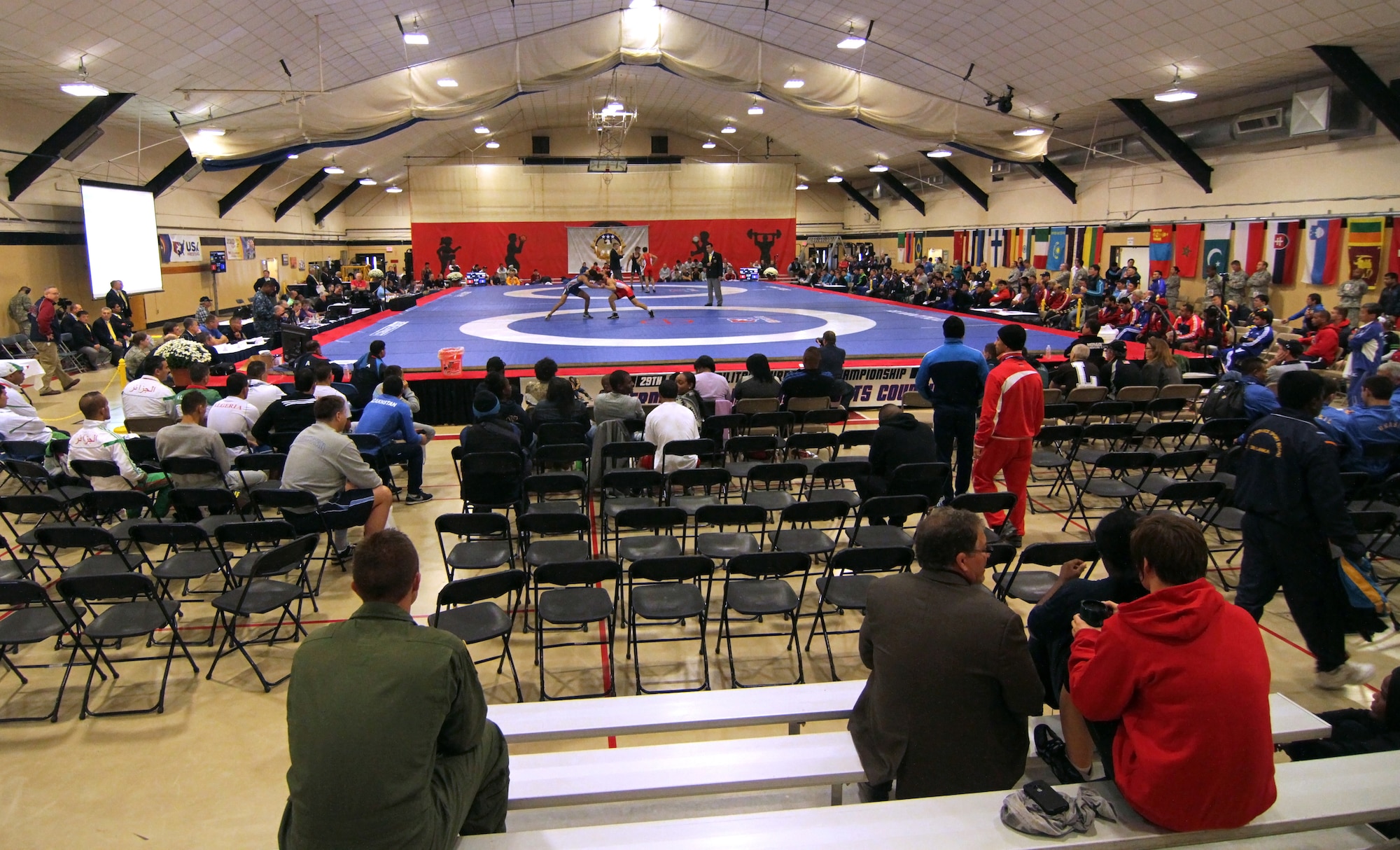 Service members wrestle in Griffith Field House and Fitness Center Oct. 3, 2014, during the International Military Sports Council World Championships at Joint Base McGuire-Dix-Lakehurst, N.J. Founded on Feb. 18, 1948, the International Military Sports Council (CISM) is one of the largest multidisciplinary organizations in the world.They organize various sporting events for the armed forces of over 134 member countries. (U.S. Army photo by Sgt. Adrian Borunda/Released)