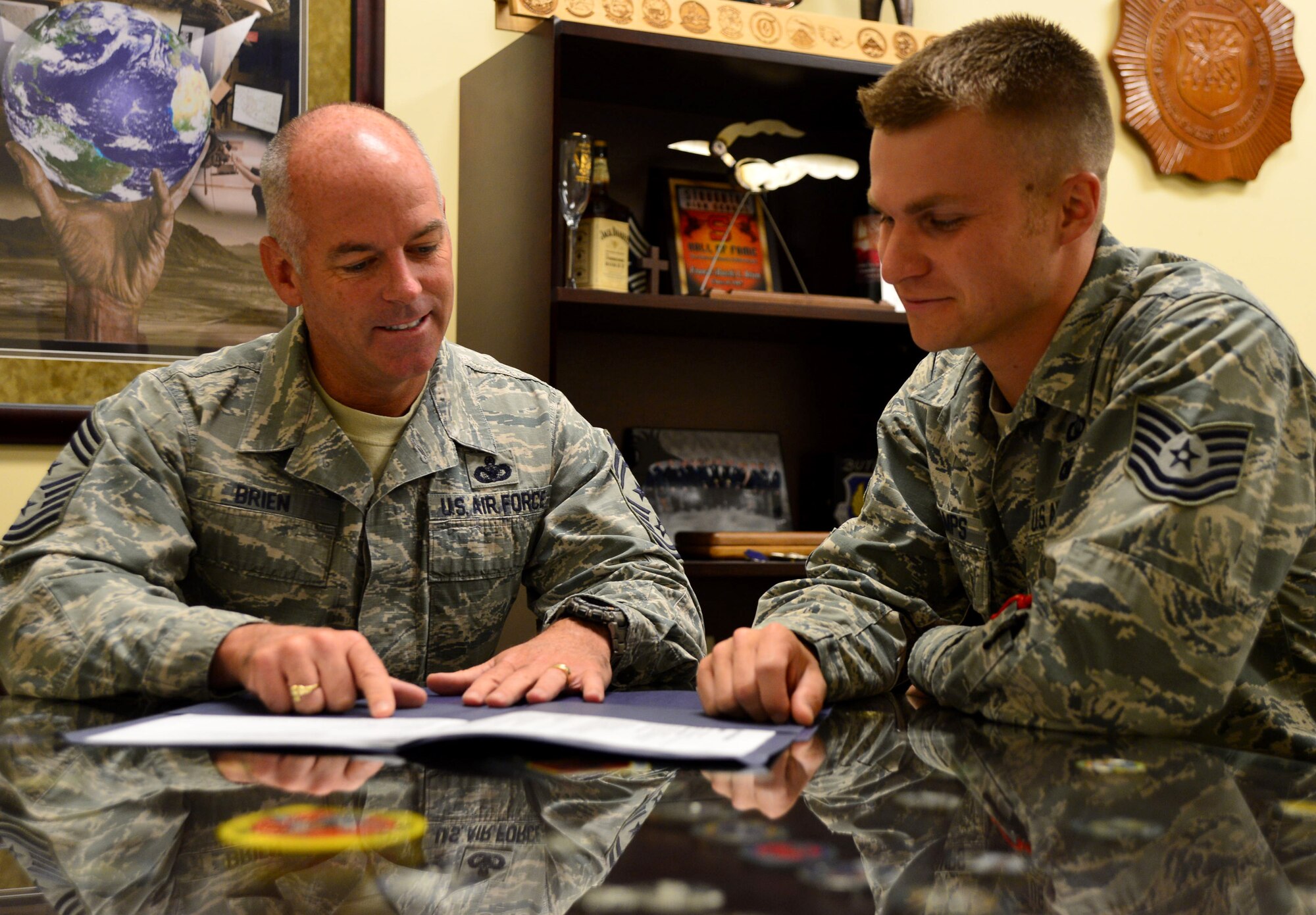Chief Master Sgt. Francis “Butch” Brien, command chief, 432nd Wing/432nd Air Expeditionary Wing, left, mentors Tech. Sgt. Noah Stamps, 432nd Wing NCO in charge of chapel operations, on his career goals June 24, 2014. Creech Airmen now have access to the Creech Airman Mentorship Program website, which launched Oct. 1, 2014 to better connect mentees with mentors in various areas.  (U.S. Air Force photo by Tech. Sgt. Nadine Barclay)