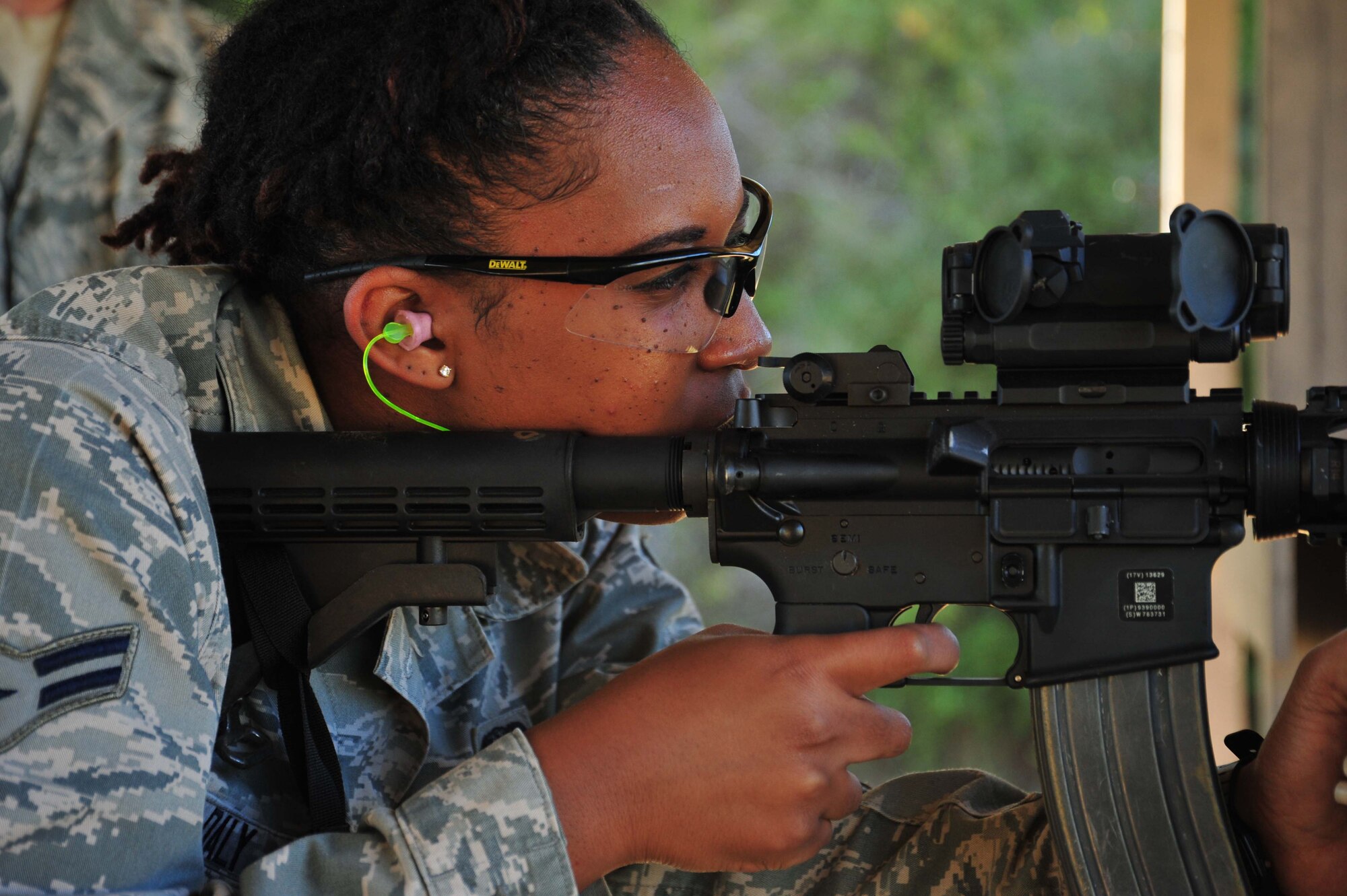 Airman 1st Class Koynelia Daly, 403rd Security Forces Squadron fire team member, lines up her target in the sights of her M4 carbine while qualifying at the Woolmarket U.S. Navy Rifle and Pistol Range, Woolmarket, Mississippi, Oct. 4, 2014. 403rd SFS members, stationed at Keesler Air Force Base, Mississippi, have been fulfilling various training requirements in preparation for their upcoming deployment to Southwest Asia. (U.S. Air Force photo/Tech. Sgt. Ryan Labadens)