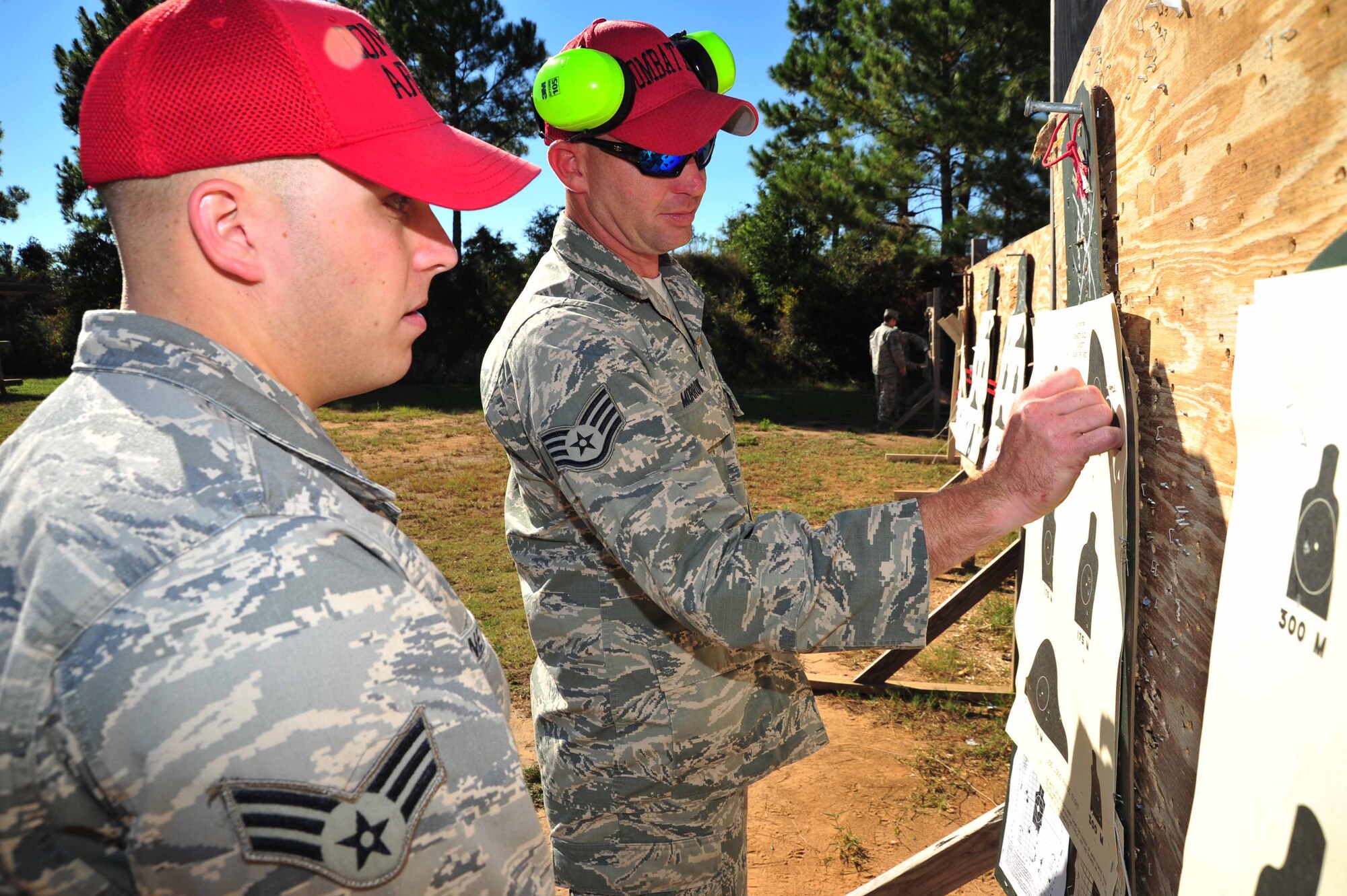 Staff Sgt. Aubrey Morrow and Senior Airman Michael Netherland, 403rd Security Forces Squadron combat arms instructors, mark how many targets were hit on a targeting sheet at the Woolmarket U.S. Navy Rifle and Pistol Range, Woolmarket, Mississippi, Oct. 4, 2014. 403rd SFS members, stationed at Keesler Air Force Base, Mississippi, have been fulfilling various training requirements in preparation for their upcoming deployment to Southwest Asia. (U.S. Air Force photo/Tech. Sgt. Ryan Labadens)