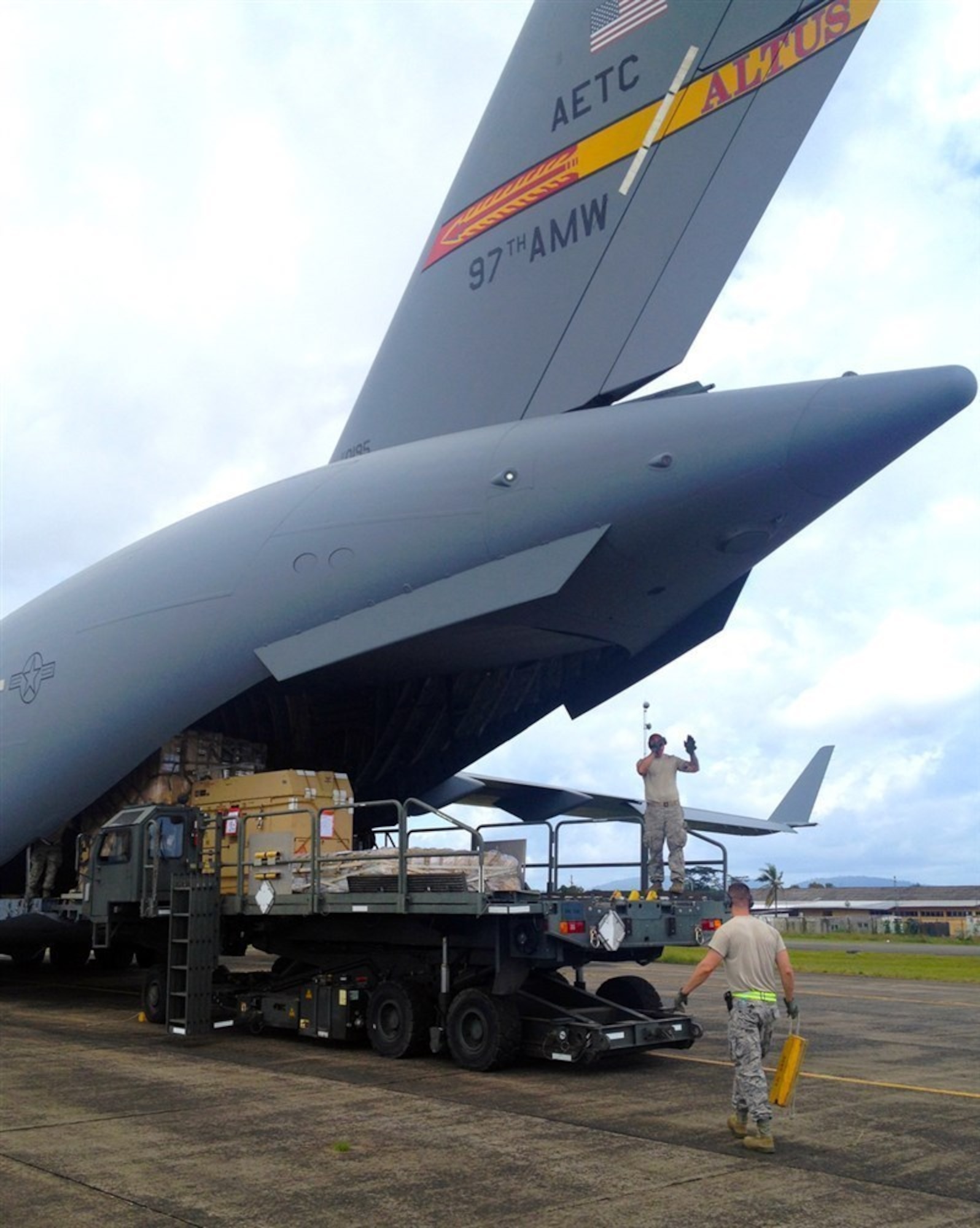 U.S. Airmen unload expeditionary medical support equipment from a U.S. Air Force C-17 Globemaster III cargo aircraft from the 97th Air Mobility Wing Sept. 30, 2014, in Monrovia, Liberia, in support of Operation United Assistance. United Assistance is a U.S. Africa Command-led operation to provide command and control, logistics, training and engineering support to the U.S. government's efforts to contain the Ebola virus outbreak in West African nations. Altus Airmen took part in Operation United Assistance, bringing more than 180,000 pounds of medical and humanitarian supplies to an Ebola stricken region. (U.S. Army photo/Released)