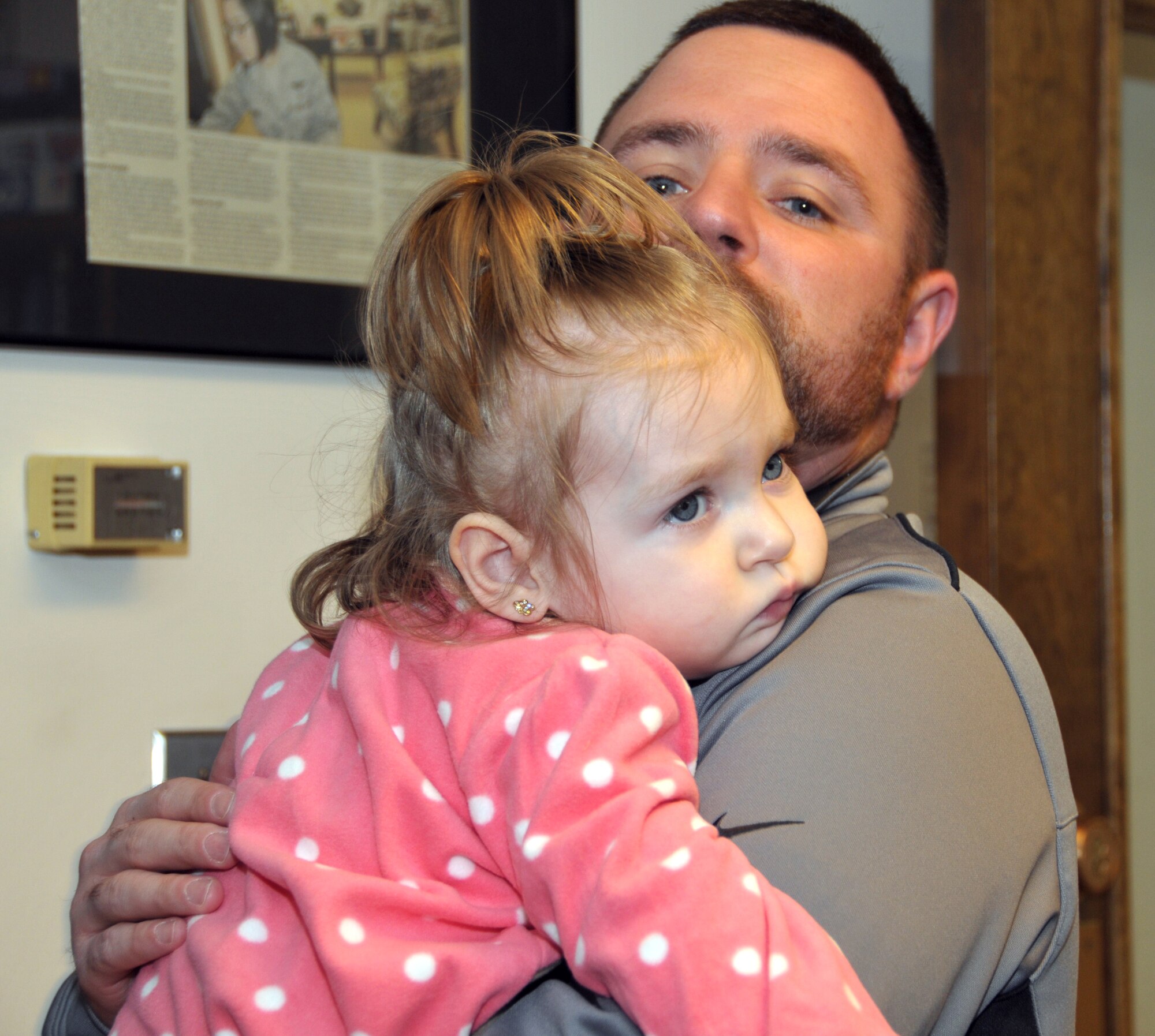 Gene LeClaire holds his 22-month-old daughter, Sophia, during a visit to the base Oct. 5, 2014. The First Six Council raised $500 during the 109th Airlift Wing Family Day to donate to the LeClaire family for medical expenses for Sophia who has cerebral palsy. (U.S. Air National Guard photo by Tech. Sgt. Catharine Schmidt/Released)