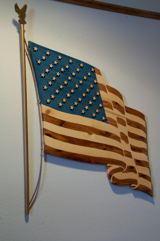An example of the woodworking skill of the F.E. Warren Arts and Crafts Center wood shop adorns the wall of an F.E. Warren building. The wood shop creates many such items made to order for customers on base. (U.S. Air Force photo by Senior Airman Jason Wiese)