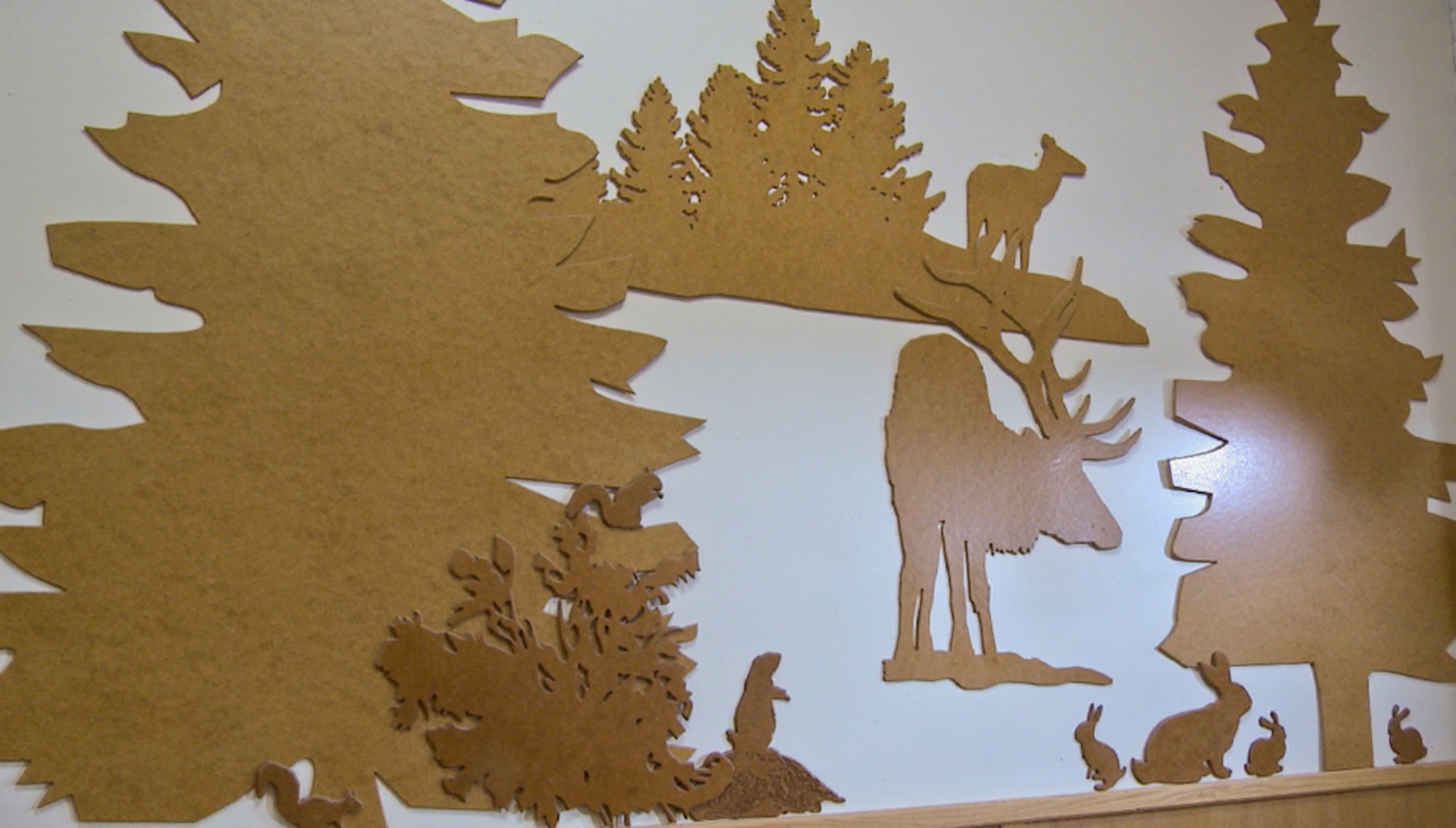 An example of the woodworking skill of the F.E. Warren Arts and Crafts Center wood shop adorns the wall of an F.E. Warren building. Much of F.E. Warren Air Force Base's charm is its relative remoteness and frontier quality. Artwork such as this contributes to this charm.  (U.S. Air Force photo by Senior Airman Jason Wiese)