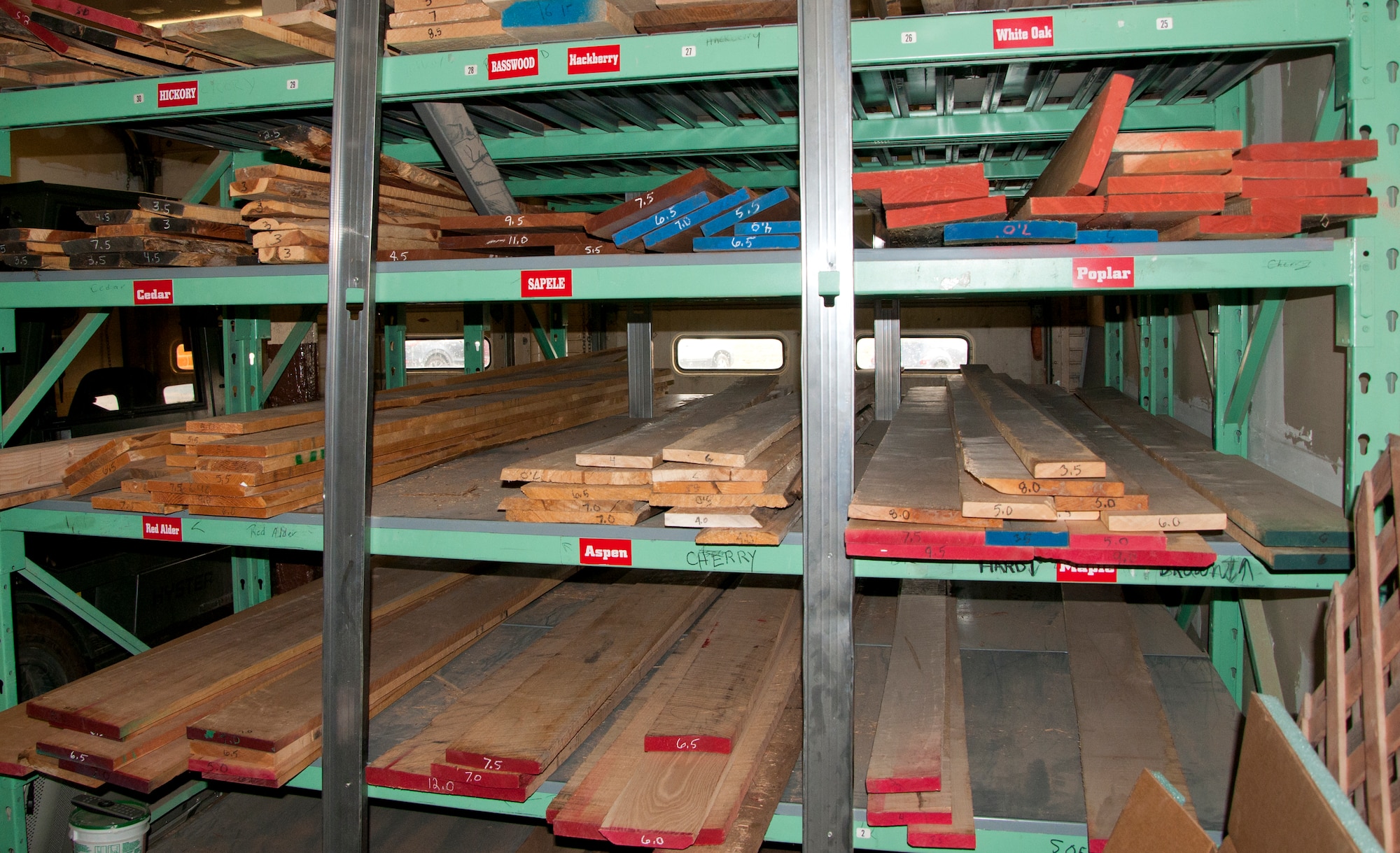 Planks of wood rest on racks in the F.E. Warren Arts and Crafts Center wood shop, waiting for use in wood crafting projects. The wood shop uses mahogany, hickory, oak and cherry in their projects. (U.S. Air Force photo by Senior Airman Jason Wiese)