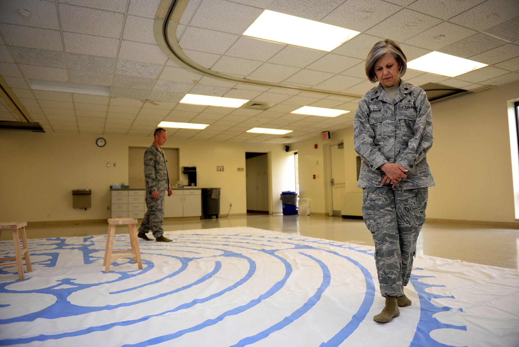 Lt. Col. Christine Blice-Baum and Maj. Erik Tisher walk on the path of a labyrinth Sept. 18 in Chapel One at Scott. The chapel is hosting an introductory "Labyrinth Lunch" Oct. 17. Blice-Baum is the 375th AMW Chaplain, and Tisher is the 375th AMW Deputy Chaplain. (U.S. Air Force photo/Senior Airman Jake Eckhardt)