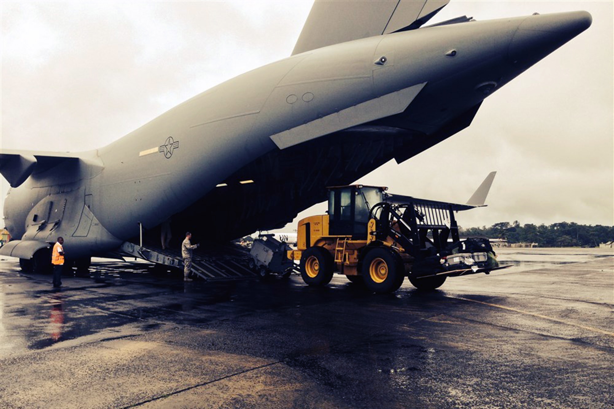 A Joint Base Lewis-McChord C-17 Globemaster III aircraft arrived in Liberia Oct. 8, with the first shipment of increased military equipment and personnel for the anti-Ebola fight, Operation Unified Assistance. The cargo included a heavy duty forklift, a drill set and generator and a team of seven military personnel, including engineers and airfield specialists. (photo courtesy/U.S. Embassy, Monrovia, Liberia)