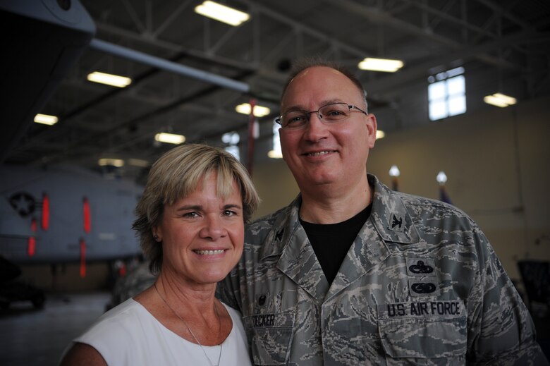 U.S. Air Force Col. Jeffrey Decker, 23d Maintenance Group commander, and his wife Angie, pose for a photo during a recent retirement ceremony Sept. 26, 2014, at Moody Air Force Base, Ga. Although the couple has only been married two years, they grew up together in Kentucky and Angie remembers when Decker would meet her at the bus stop to carry her school books. (U.S. Air Force photo by Andrea Jenkins)
