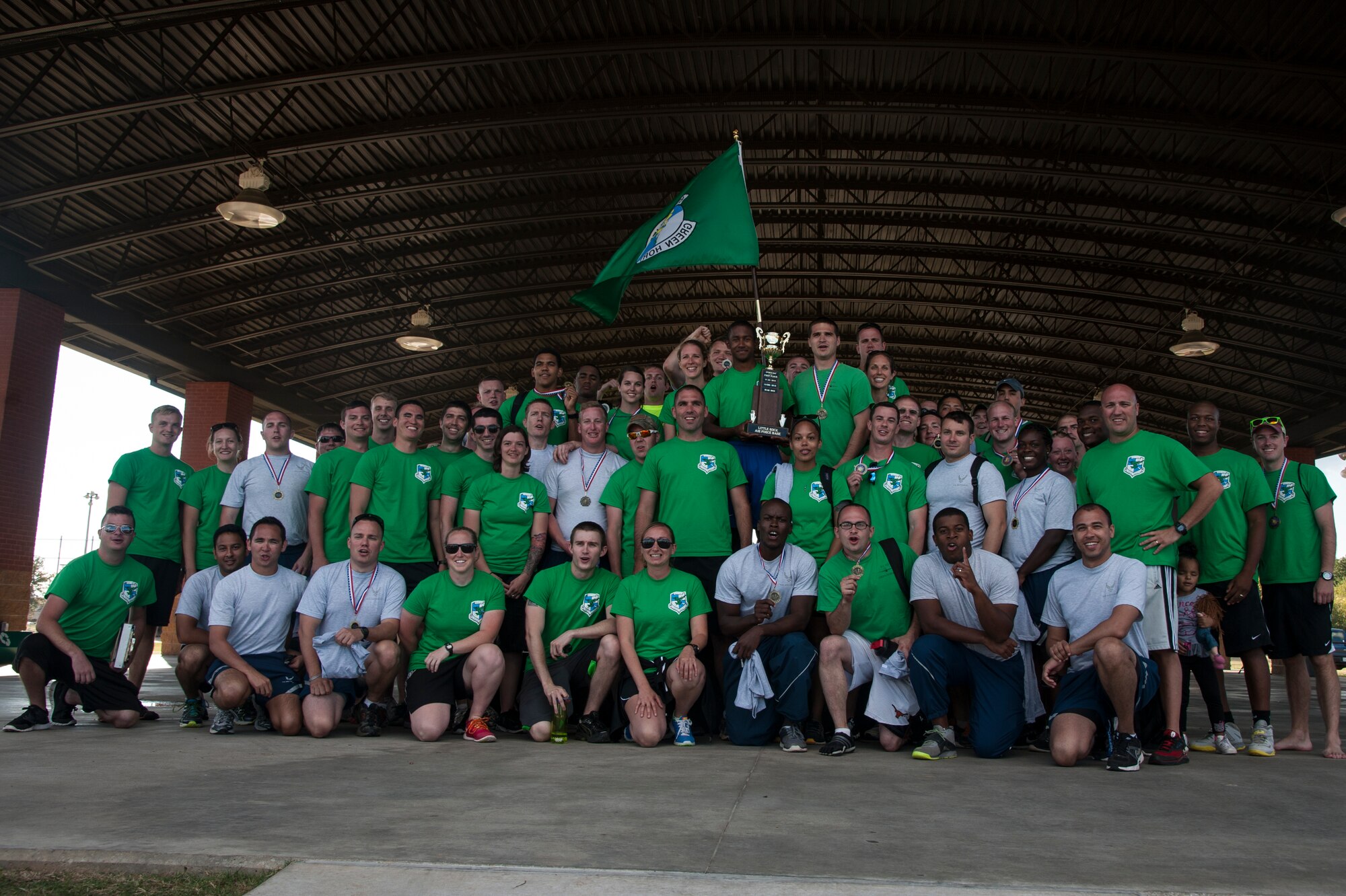 Members of the 61st Airlift Squadron pose with their Sports Day trophy Oct. 3, 2014, at Little Rock Air Force Base, Ark. The 61st Airlift Squadron was recognized as the overall Sports Day champions. (U.S. Air Force photo by Senior Airman Kaylee Clark)