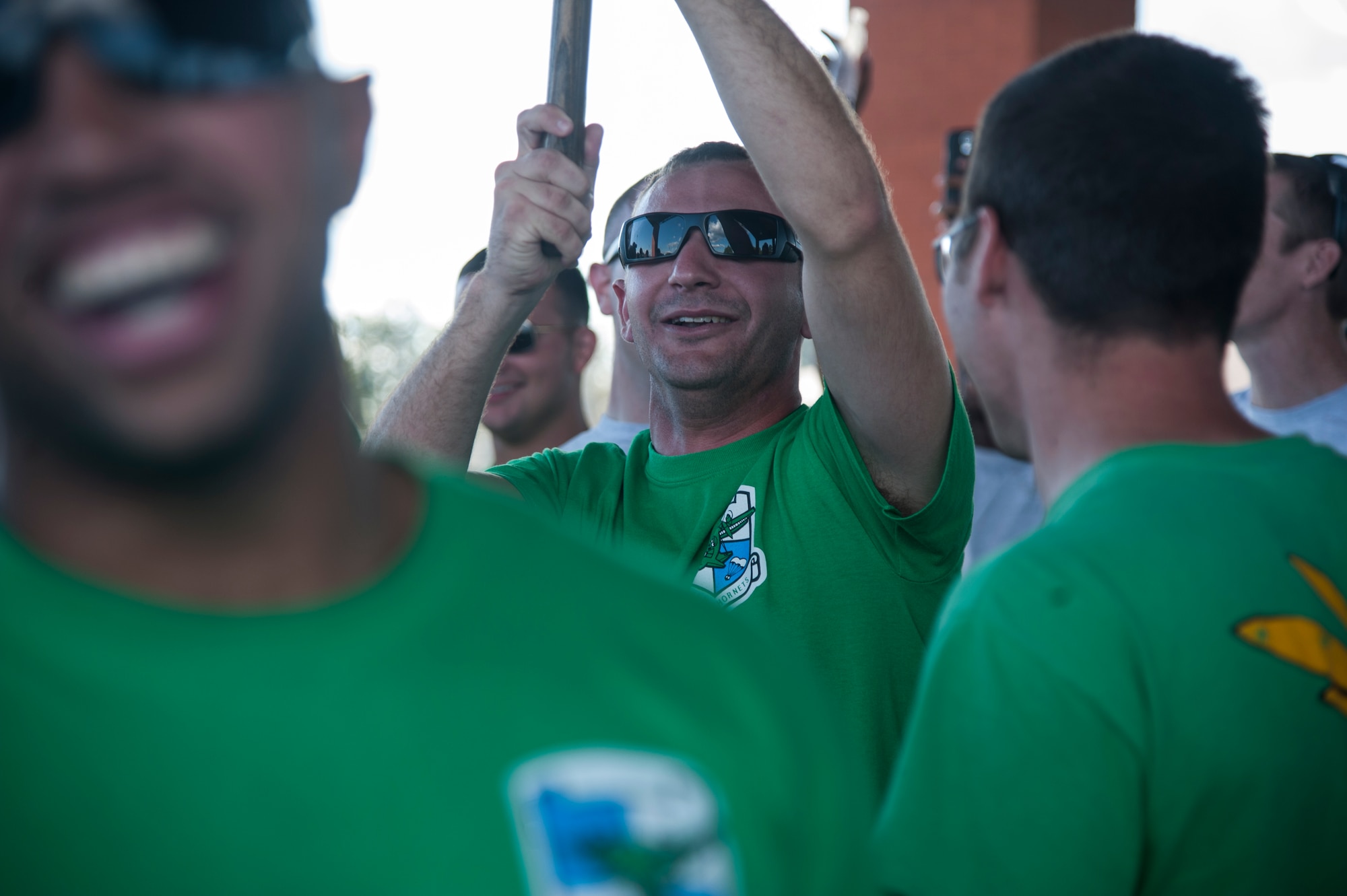 Senior Airman Sean Zeringue, a 61st Airlift Squadron loadmaster, celebrates with his squadron after being crowned the winners of Sports Day Oct. 3, 2014, at Little Rock Air Force Base, Ark. The 61st AS were victorious in the ultimate Frisbee, obstacle course and tug-of-war competitions. (U.S. Air Force photo by Senior Airman Kaylee Clark)