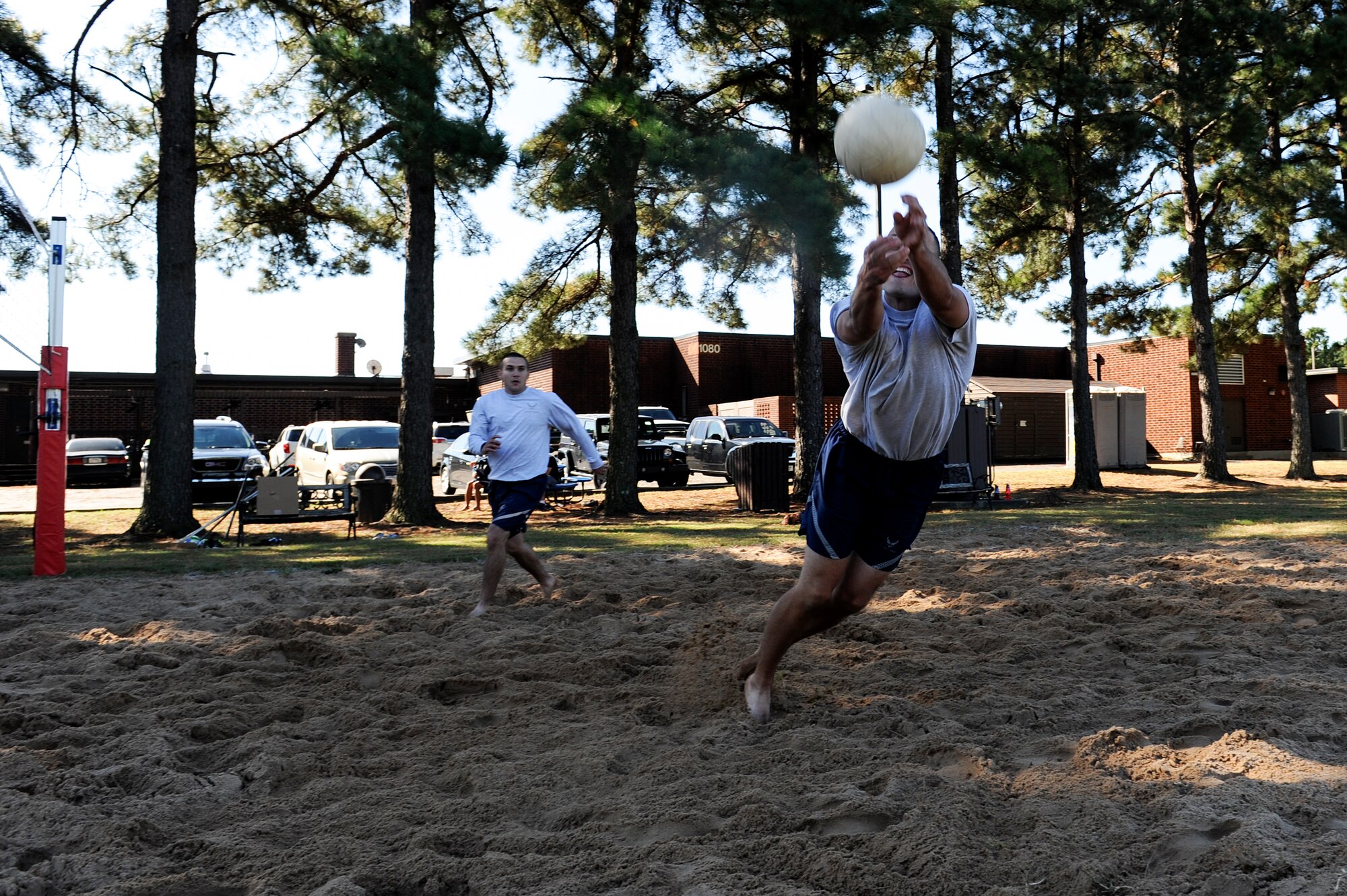A member of the 19th Civil Engineer Squadron jumps for the volleyball during the outdoor volleyball challenge Oct. 3, 2014, at Little Rock Air Force Base, Ark. The volleyball challenge was part of the events that took place during the 19th Airlift Wing Sports Day, and first place was awarded to the 19th Civil Engineer Squadron. (U.S. Air Force photo by Staff Sgt. Jessica Condit)