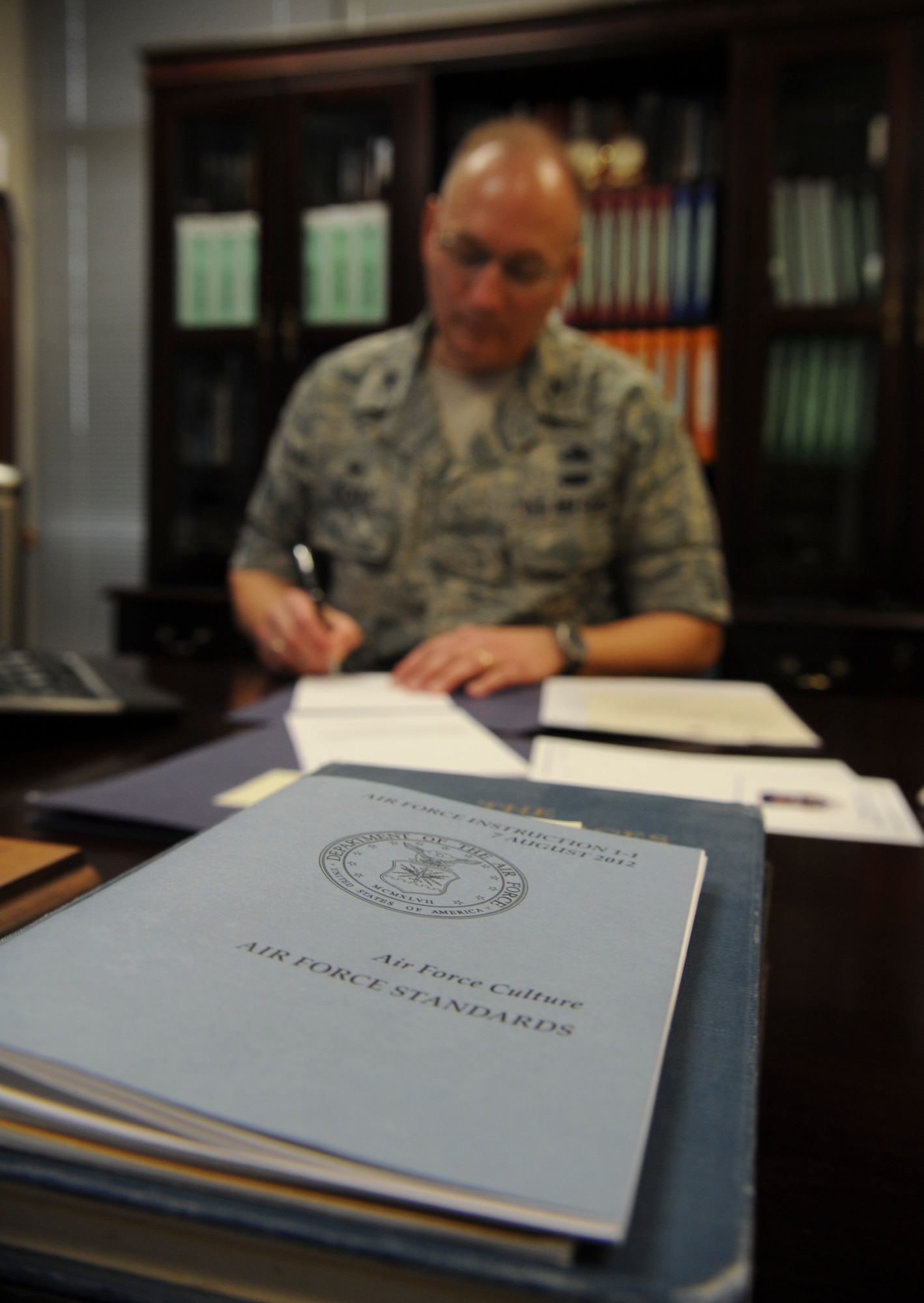 U.S. Air Force Col. Jeffrey Decker, 23d Maintenance Group commander, signs letters of appreciation for Airmen of the MXG Sept. 25, 2014 at Moody Air Force Base, Ga. Decker is a firm believer in acknowledging Airmen for their achievements on and off duty. (U.S. Air Force photo by Andrea Jenkins)