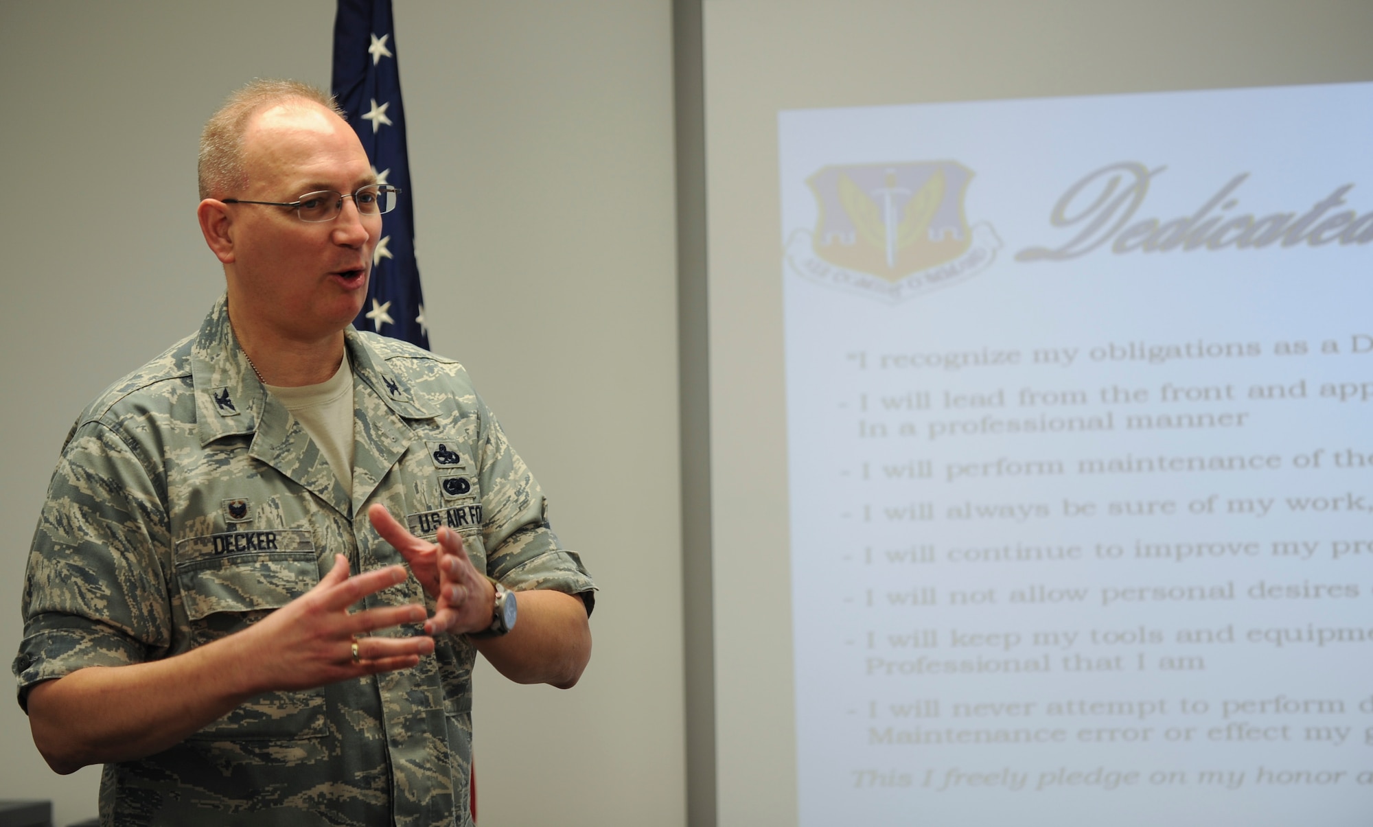 U.S. Air Force Col. Jeffrey Decker, 23d Maintenance Group commander, speaks to recent graduates of the dedicated crew chief class Sept. 25 2014, at Moody Air Force Base, Ga. Decker told stories about his time as an enlisted avionics Airman. (U.S. Air Force photo by Andrea Jenkins)