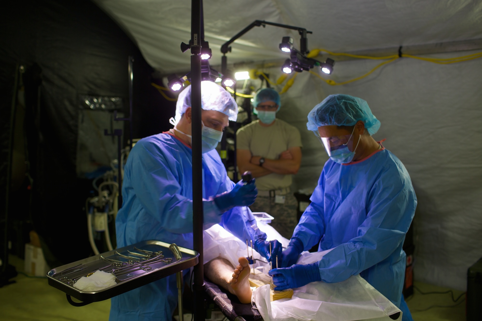 Maj. Ryan Earnest, 48th Medical Group general surgeon, places an external fixator under Maj. Joshua Young's guidance during Exercise Immediate Response in Slovenia. Young is an orthopedic surgeon with the 48th MDG. The skills of the 48th MDG personnel were tried and tested during this exercise to ensure they remain forward, ready, now as they built international relationships. (U.S. Air Force Photo by Maj. Joshua Young/Released)