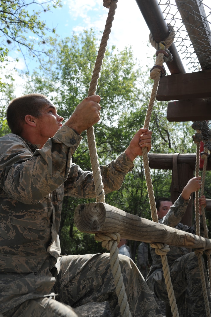 Basic military trainees climb up rope-and-wood ladders as part of the basic military training obstacle course at Joint Base San Antonio-Lackland, Sept. 24, 2014. The trainees completed the last run of course before its permanent closure the same day. A new course, called the Leadership Reaction Course, was added to basic expeditionary Airmen’s training, also known as BEAST week, at JBSA-Lackland Medina Annex and became fully operational Sept. 29.  (U.S. Air Force photo by Senior Airman Krystal Jeffers/Released)