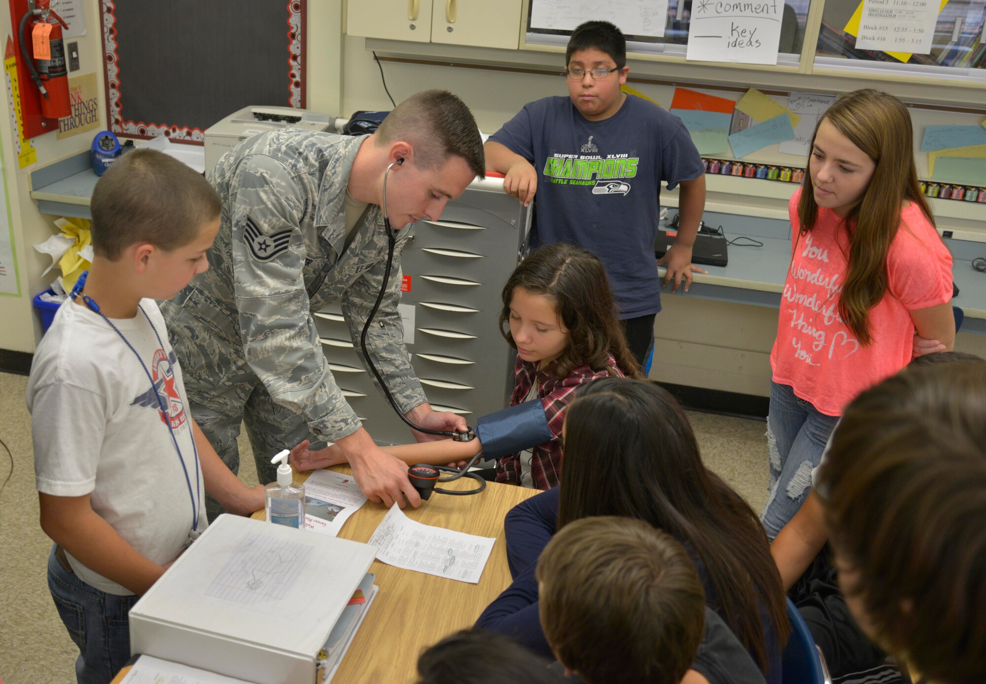 Staff Sgt. Michael Palmer, 93rd Air Refueling Squadron independent duty medical technician, checks a student’s blood pressure during Glover Middle School’s 18th Annual Discovery Day Oct. 8, 2014 in Spokane, Wash. Fairchild Airmen briefed 670 students about the Air Force and the base’s mission. (U.S. Air Force photo by Airman 1st Class Janelle Patiño)