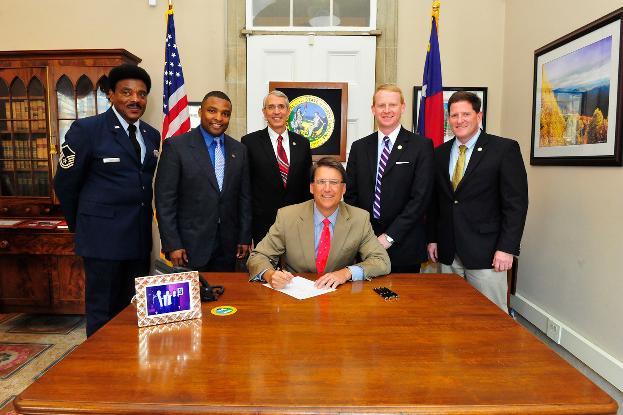 Col. J. Chris Whitmire, an Emergency Preparedness Liaison Officer and member of the North Carolina House of Representatives, far right, is pictured with fellow North Carolina Lawmakers and Gov. Pat McCrory for the signing of the Brass to Class act, which streamlines the process veterans must follow to transition into public classrooms as teachers by ensuring they are granted credit for their relevant experience, formal certifications and training, leadership roles and formal education. Whitmire was a primary sponsor of the bill. (Courtesy photo)   