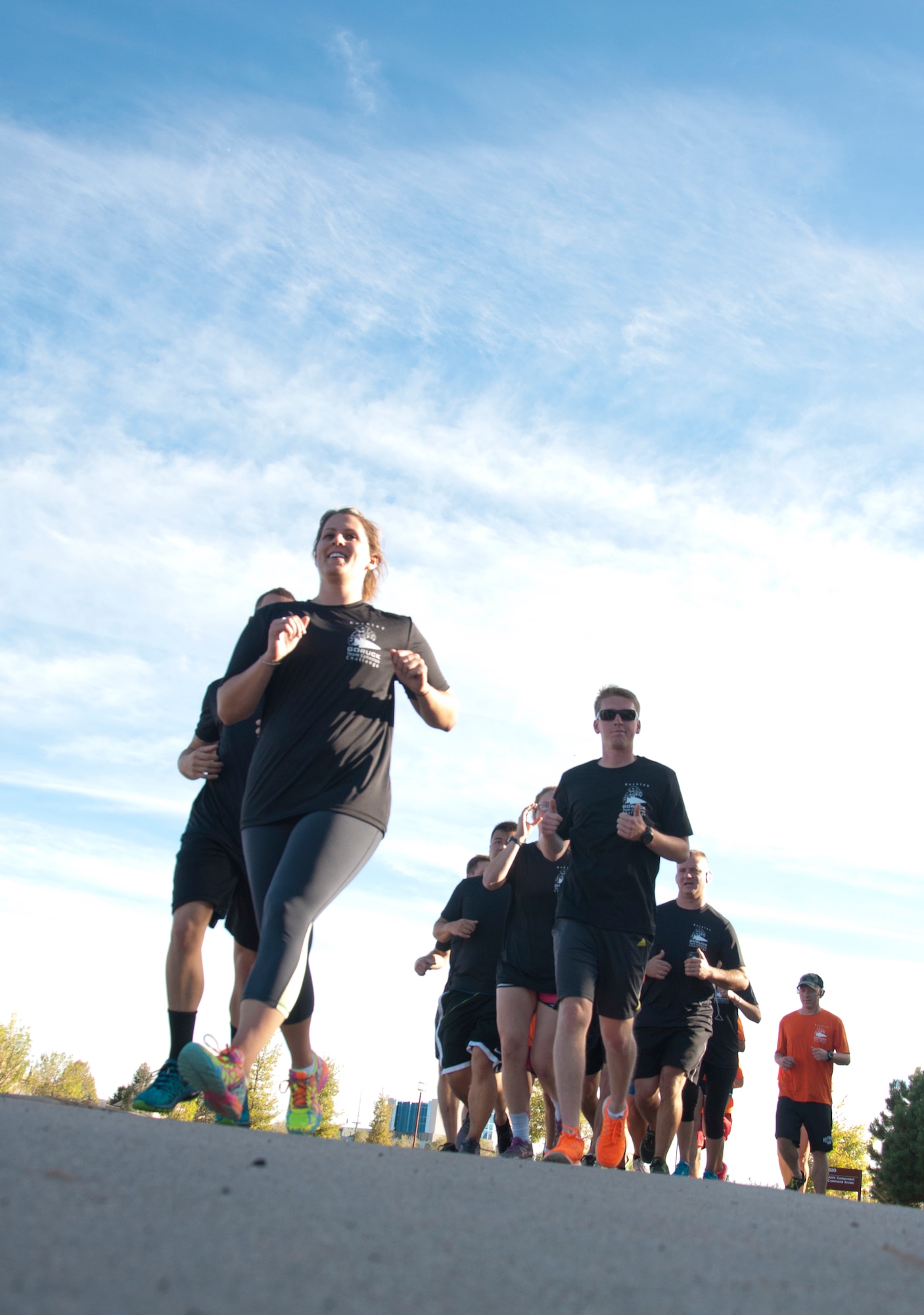 Team Buckley members run the Team Cohesion Challenge 5K Oct. 7, 2014, at the track on Buckley Air Force Base, Colo. The 5K kicked off the Team Cohesion Challenge, a GORUCK event made available to all Team Buckley members to incorporate the Five C's of Comprehensive Airmen Fitness: Caring, Committing, Connecting, Communicating and Celebrating. (U.S. Air Force photo by Tech. Sgt. Kali L. Gradishar/Released) 
