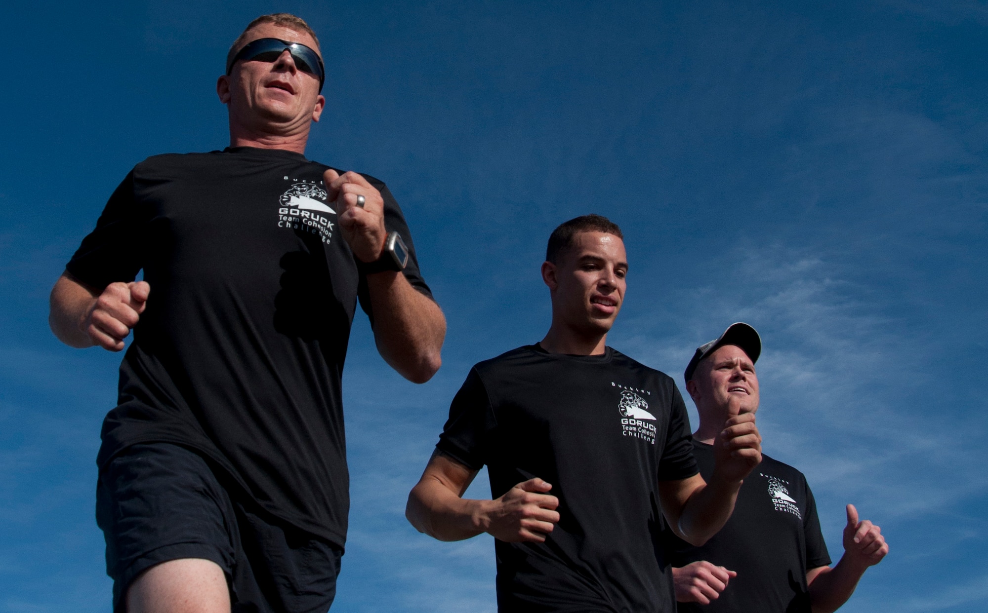 Team Buckley members run the Team Cohesion Challenge 5K Oct. 7, 2014, at the track on Buckley Air Force Base, Colo. The 5K kicked off the Team Cohesion Challenge, a GORUCK event made available to all Team Buckley members to incorporate the Five C's of Comprehensive Airmen Fitness: Caring, Committing, Connecting, Communicating and Celebrating. (U.S. Air Force photo by Tech. Sgt. Kali L. Gradishar/Released) 