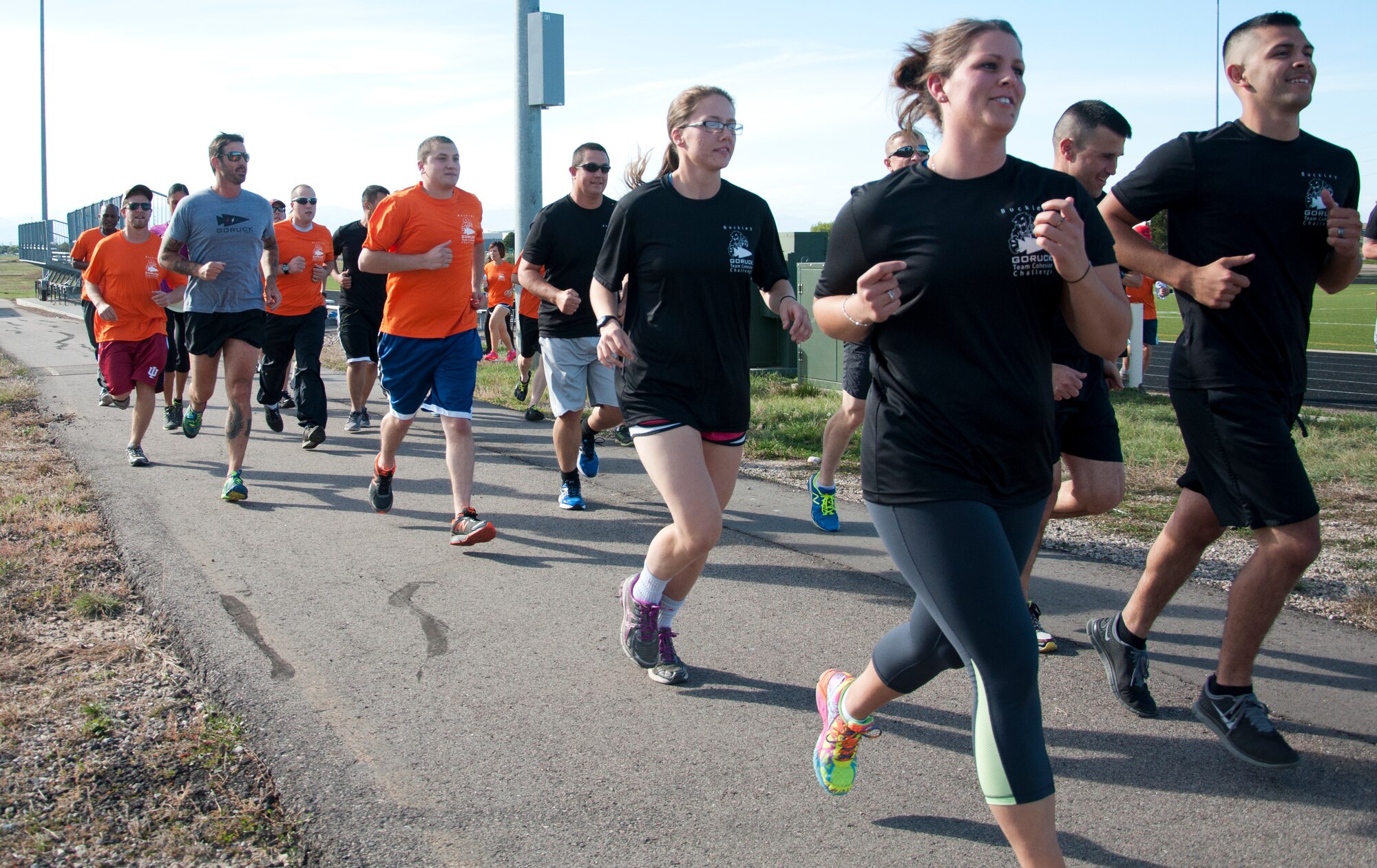 Team Buckley members start the Team Cohesion Challenge 5K Oct. 7, 2014, at the track on Buckley Air Force Base, Colo. The 5K kicked off the Team Cohesion Challenge, a GORUCK event made available to all Team Buckley members to incorporate the Five C's of Comprehensive Airmen Fitness: Caring, Committing, Connecting, Communicating and Celebrating. (U.S. Air Force photo by Tech. Sgt. Kali L. Gradishar/Released) 