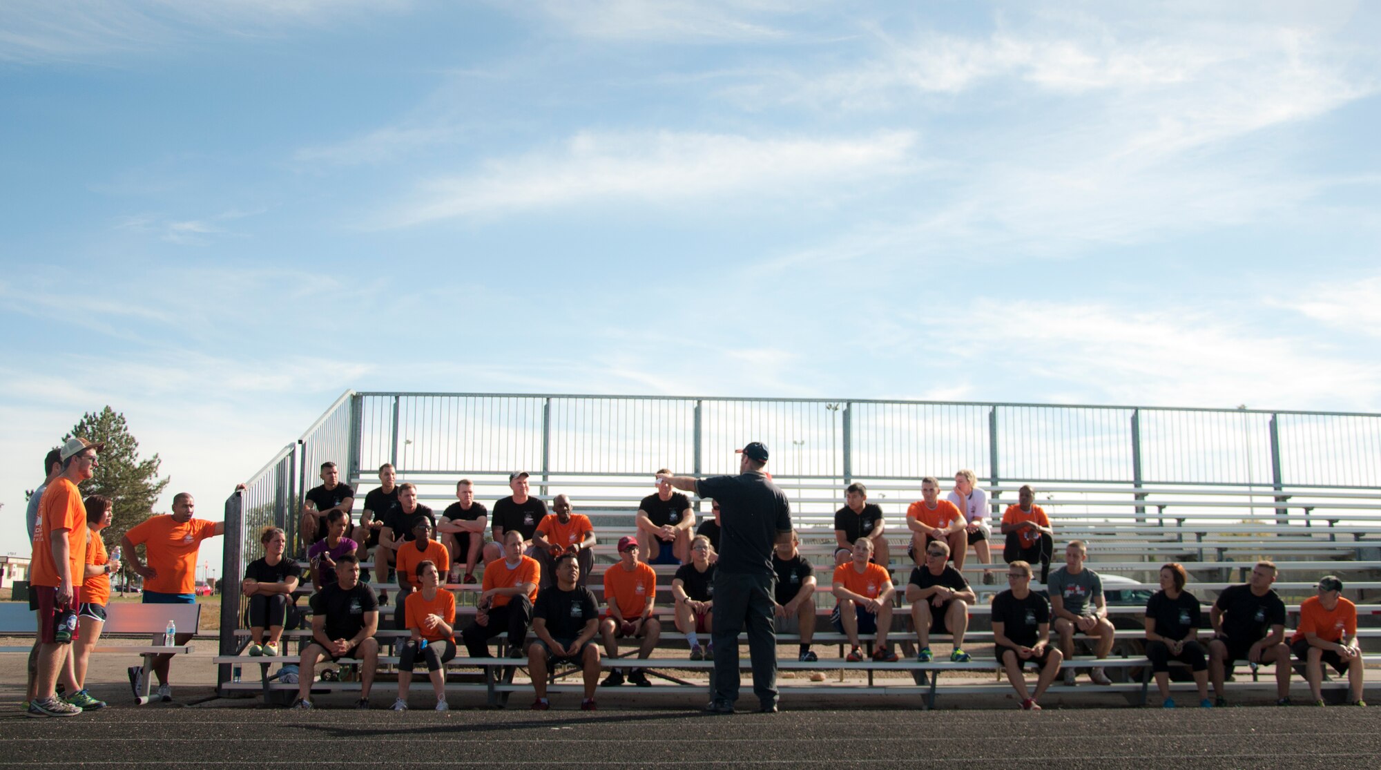 Jeffrey Heagerty, Buckley Outdoor Recreation Center manager, standing center, briefs participants before the start of the Team Cohesion Challenge 5K Oct. 7, 2014, at the track on Buckley Air Force Base, Colo. The 5K kicked off the Team Cohesion Challenge, a GORUCK event made available to all Team Buckley members to incorporate the Five C's of Comprehensive Airmen Fitness: Caring, Committing, Connecting, Communicating and Celebrating. (U.S. Air Force photo by Tech. Sgt. Kali L. Gradishar/Released) 
