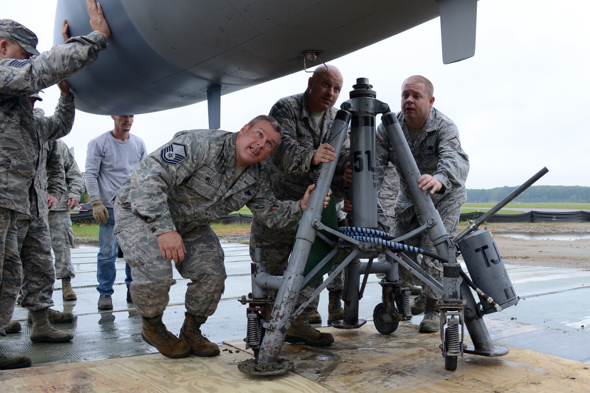 U.S. Air National Guard Master Sgt. Thomas Mills and U.S. Air Force Master Sergeants Michael DiVietro and Danny Merritt, 1st Maintenance Group crash recovery team chiefs, move a temporary stand into place for an F-15 Eagle static display at Langley Air Force Base, Va., Oct. 4, 2014. In 1976, a schoolgirl named Terri Morris won a contest to name the Eagle the “Peninsula Patriot.” (U.S. Air Force photo by Airman 1st Class Devin Scott Michaels/Released)