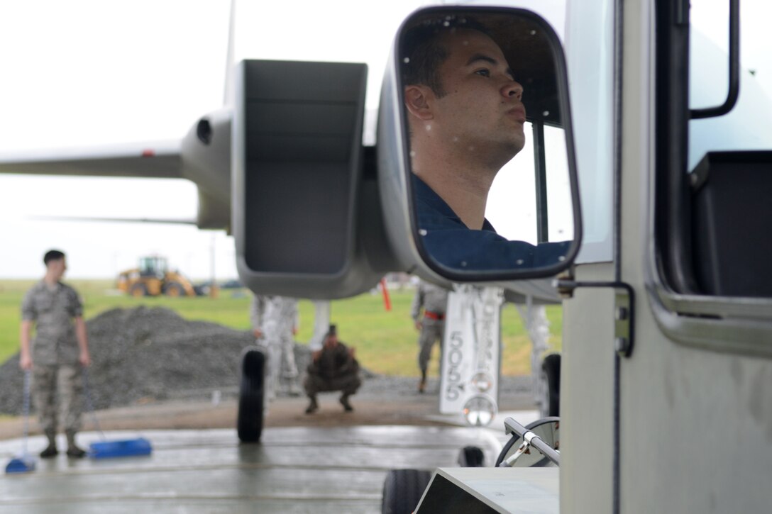 U.S. Air Force Staff Sgt. Kevin Weisser, 1st Maintenance Group crash recovery technician, adjusts the position of an F-15 Eagle static display using an aircraft tow tractor at Langley Air Force Base, Va., Oct. 4, 2014. The Eagle being put on display was the last F-15 to fly a mission out of Langley Air Force Base. (U.S. Air Force photo by Airman 1st Class Devin Scott Michaels/Released)